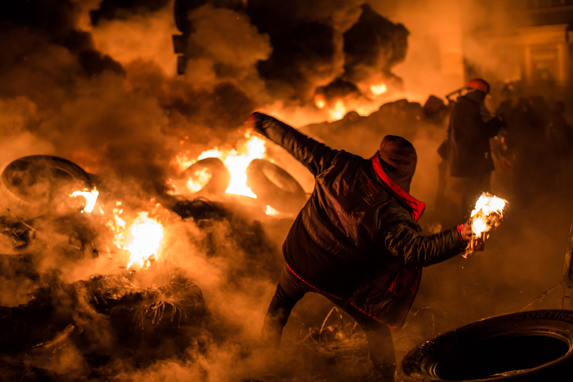  An anti-government protester throws a Molotov cocktail during clashes with police on Hrushevskoho Street near Dynamo stadium on January 25, 2014 in Kiev, Ukraine. After two months of primarily peaceful anti-government protests in the city center, ne