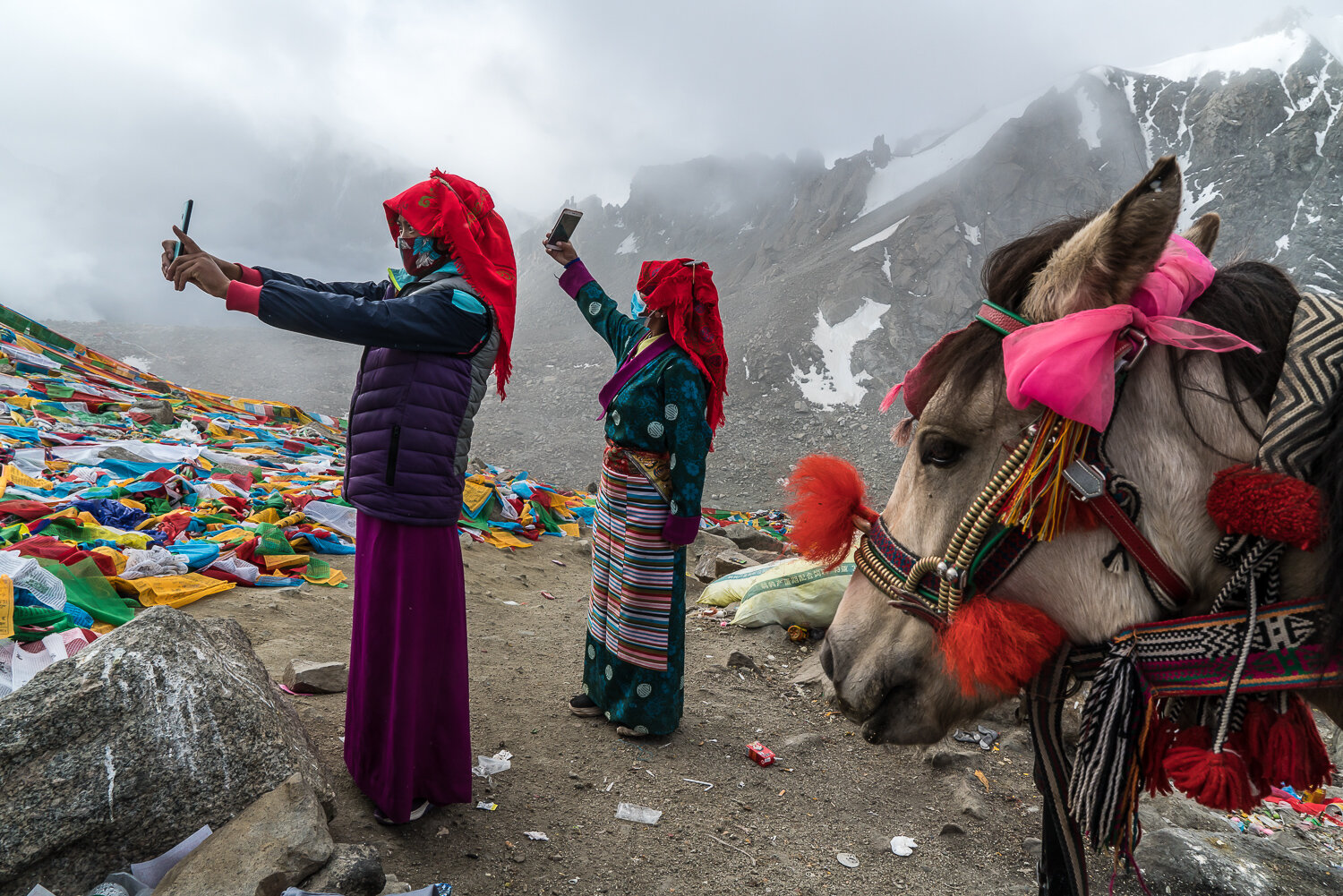  Buddhist pilgrims at the Drolma La, the highest point of the kora around Mount Kailash (5630 meters, or nearly 18,500 feet) take selfies on Thursday, September 12, 2019 in Burang County, Ngari Prefecture, Tibet, China. The mountain is considered sac