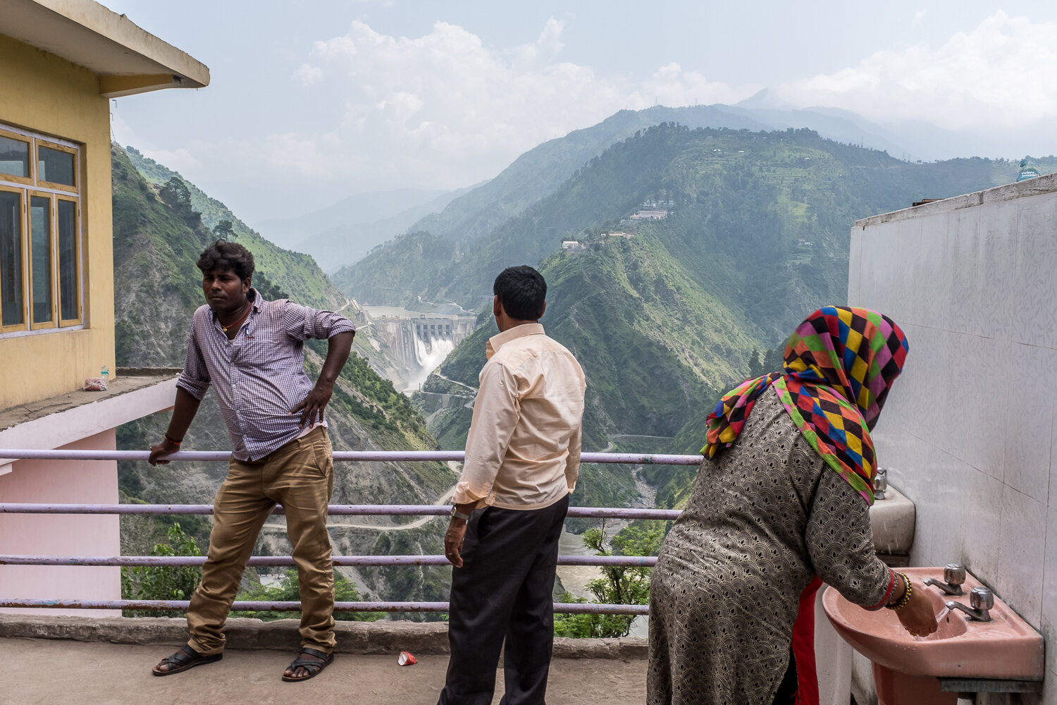 The Baglihar Dam, a hydroelectric power project on the Chenab River, stands in the valley behind patrons of a roadside cafe on Wednesday, August 9, 2017 in Baglihar, Jammu & Kashmir, India. The Chenab River is one of the major tributaries of the Ind