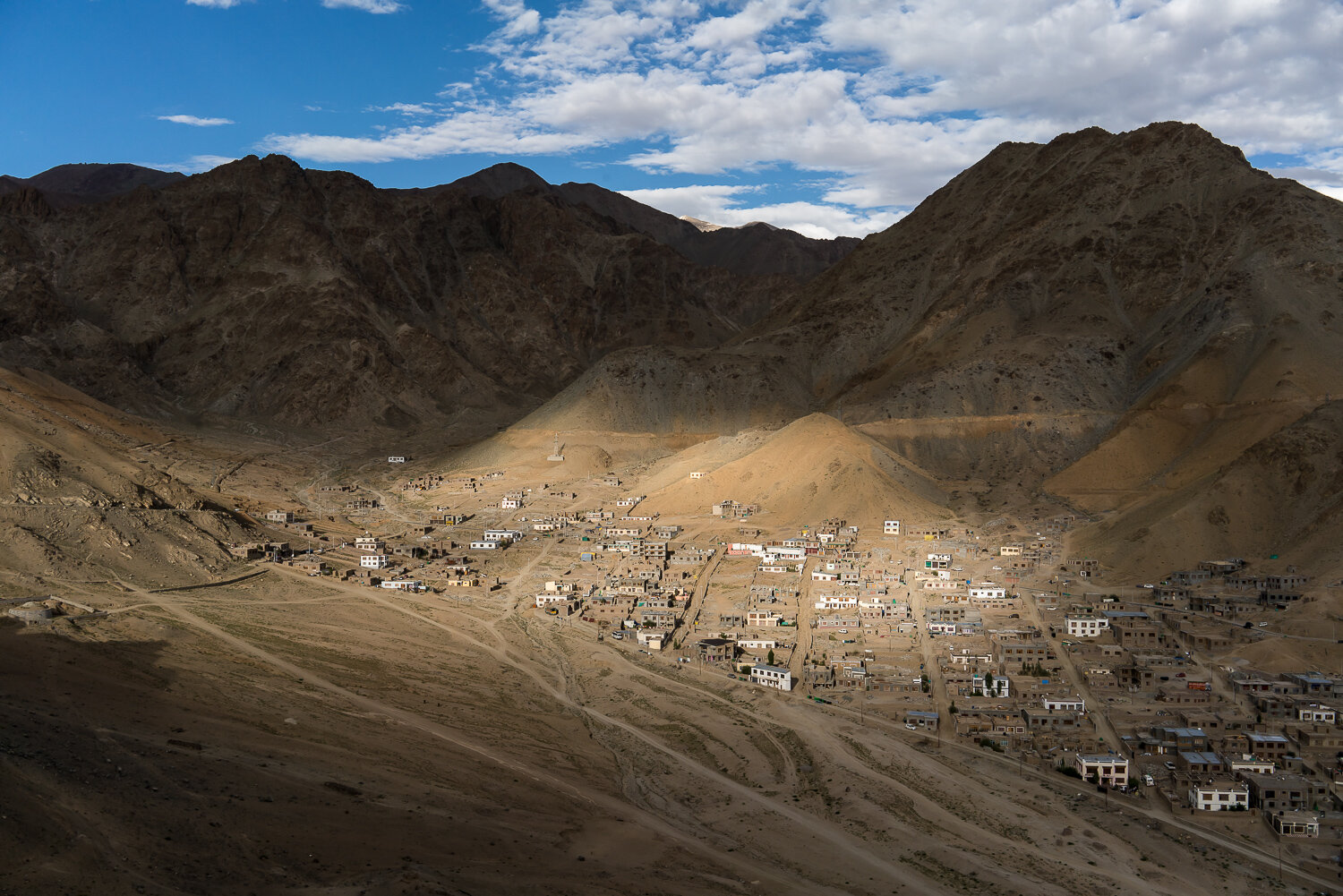  The rapidly-expanding Skampari neighborhood, which does not enjoy the same ease of access to fresh water as some other areas of the city, as seen from the Namgyal Tsemo Temple on Thursday, August 8, 2019 in Leh, Ladakh, India. As Leh expands, the su
