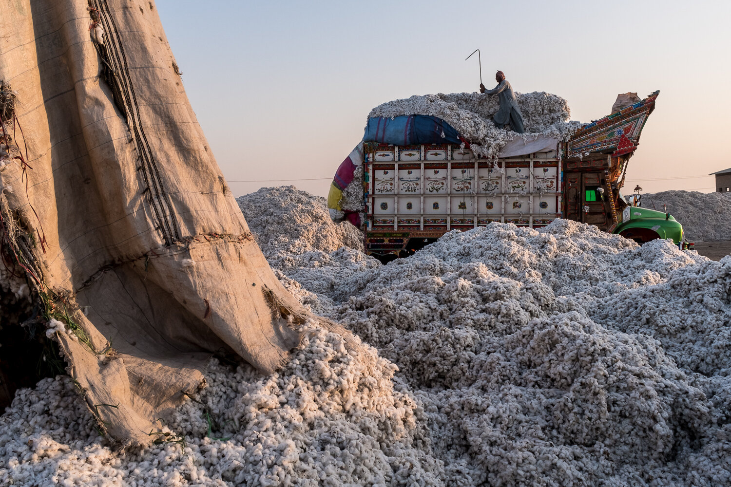  A truck delivering recently-picked cotton is unloaded at Usman Marvandi Cotton Industries on Tuesday, November 28, 2017 in Bubak, Sindh, Pakistan. Cotton is a very water-intensive crop to grow, but it is a major agricultural commodity for Pakistan; 