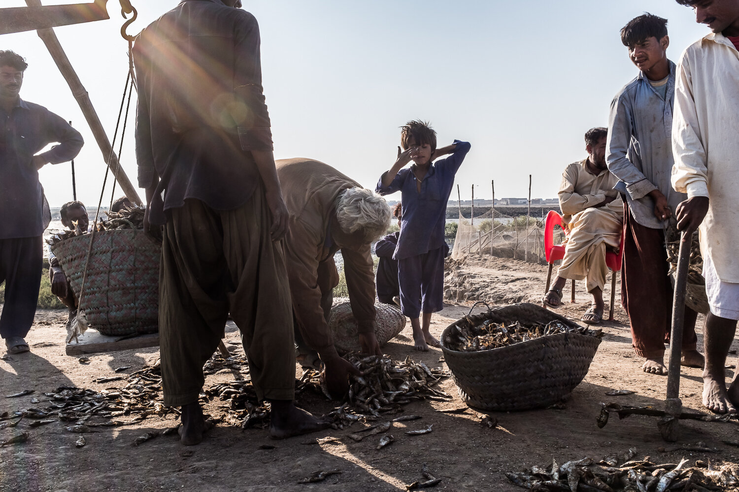  Fishermen weigh dried fish on Friday, December 1, 2017 in Keti Bandar, Sindh, Pakistan. At the very tip of the Indus River delta, fishing is no longer as lucrative as it once was, due to reduced river flows and fewer fish. As a result, fishermen are