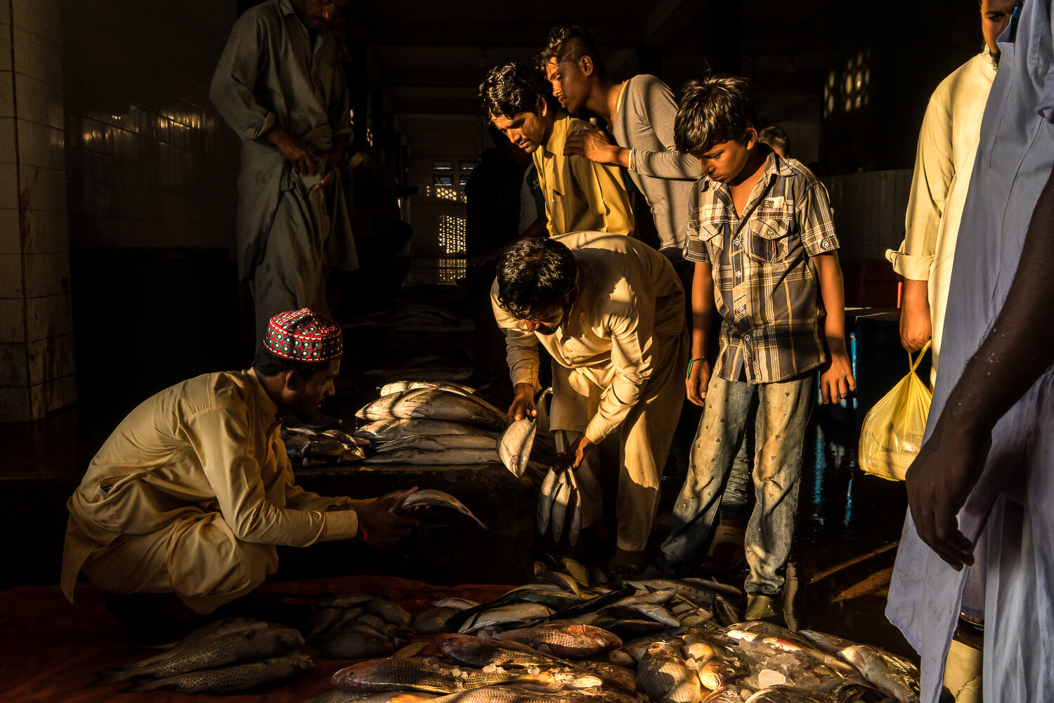  Buyers inspect fish for sale in the main Karachi fish market on Saturday, October 12, 2019 in Karachi, Sindh, Pakistan. 