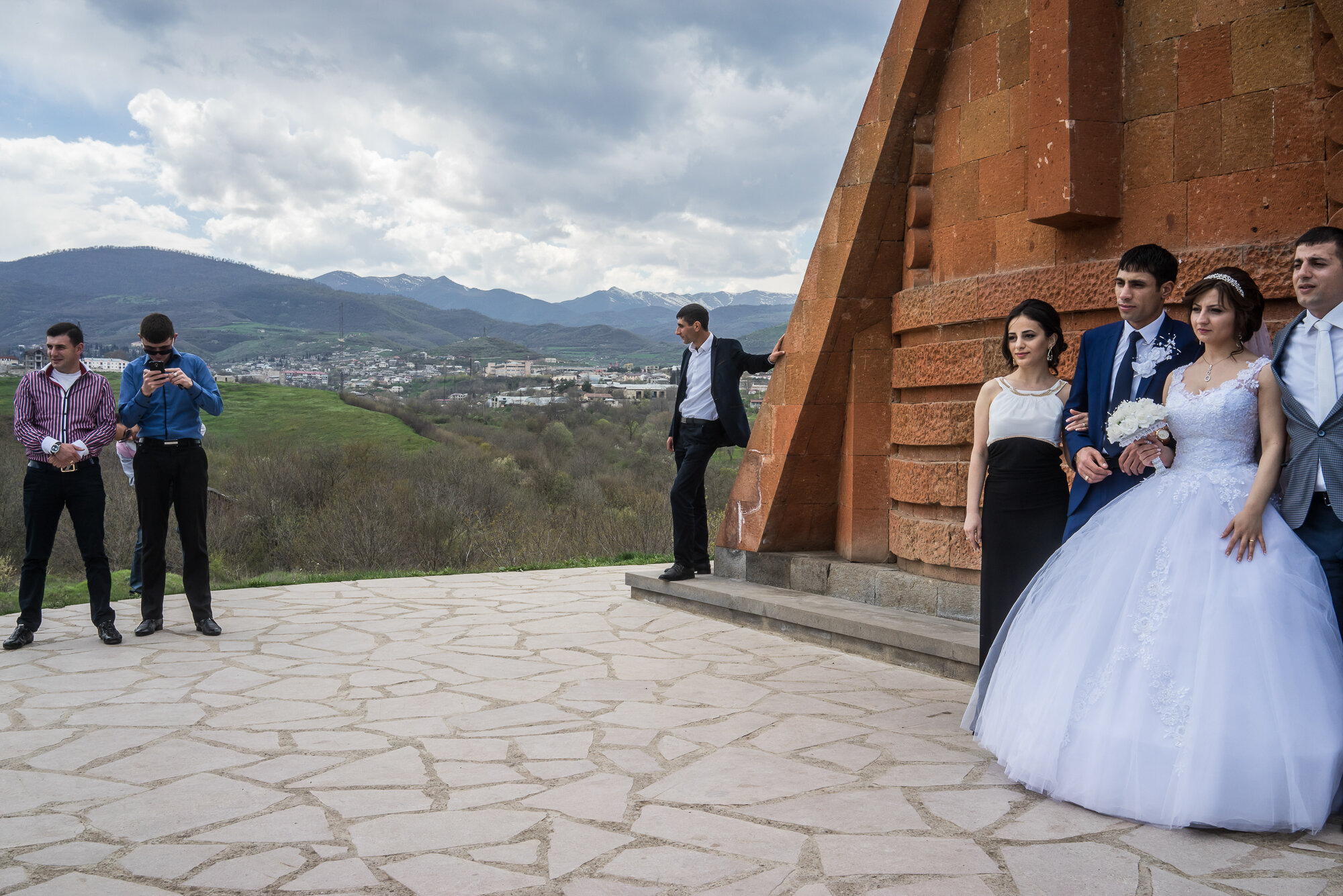  Groom Davit Simonyan, 24, and bride Shogher Hovsepyan, 25, take wedding photos with family and friends at the Tatik Papik monument, a popular symbol of Nagorno-Karabakh. Stepanakert, Nagorno-Karabakh. 2015. 