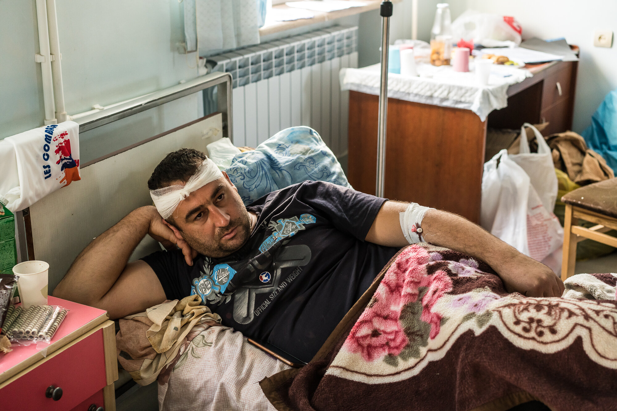  Aghajan, an Armenian soldier wounded in fighting the previous day, lies in his hospital bed. Stepanakert, Nagorno-Karabakh. 2020. 
