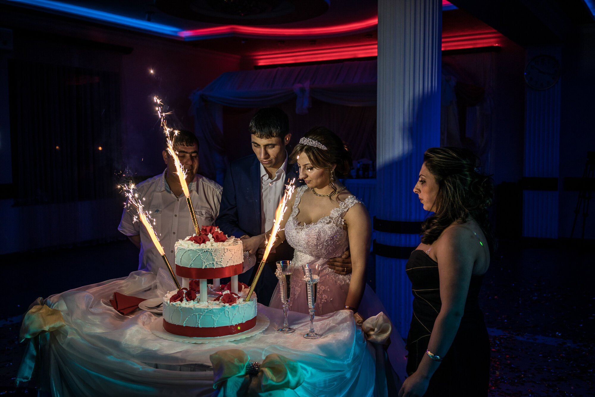  Groom Davit Simonyan, 24, and bride Shogher Hovsepyan, 25, prepare to cut the cake at their wedding reception. Stepanakert, Nagorno-Karabakh. 2015. 
