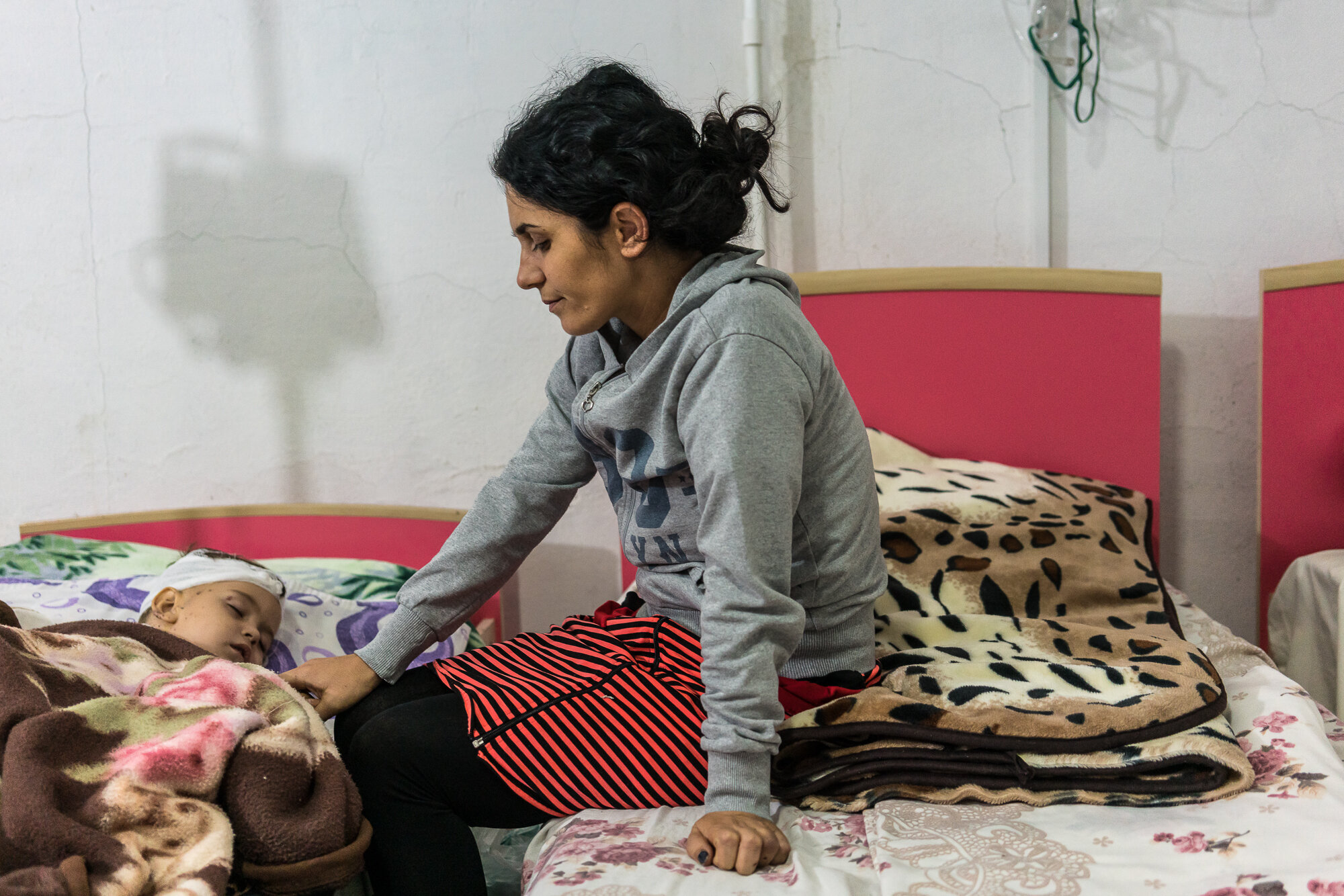  Anahit Gevorgyan sits with her son Artsvik, 2, after he was injured and her eight-year-old daughter killed by fighting in their village of Martuni two days earlier. Stepanakert, Nagorno-Karabakh. 2020. 