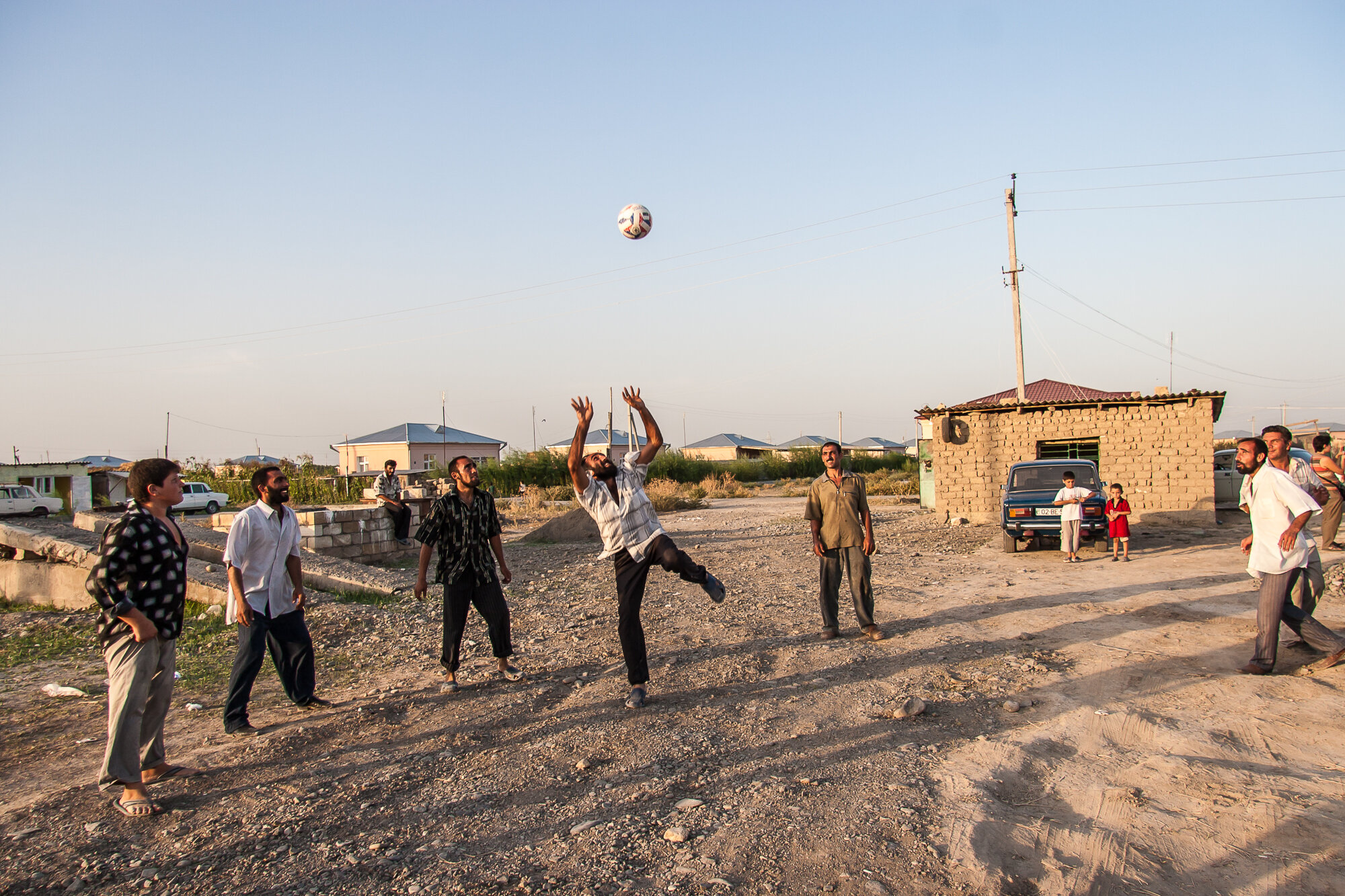  Men hit a soccer ball in a camp for internally displaced people from Nagorno-Karabakh. Agdam region, Azerbaijan. 2006. 