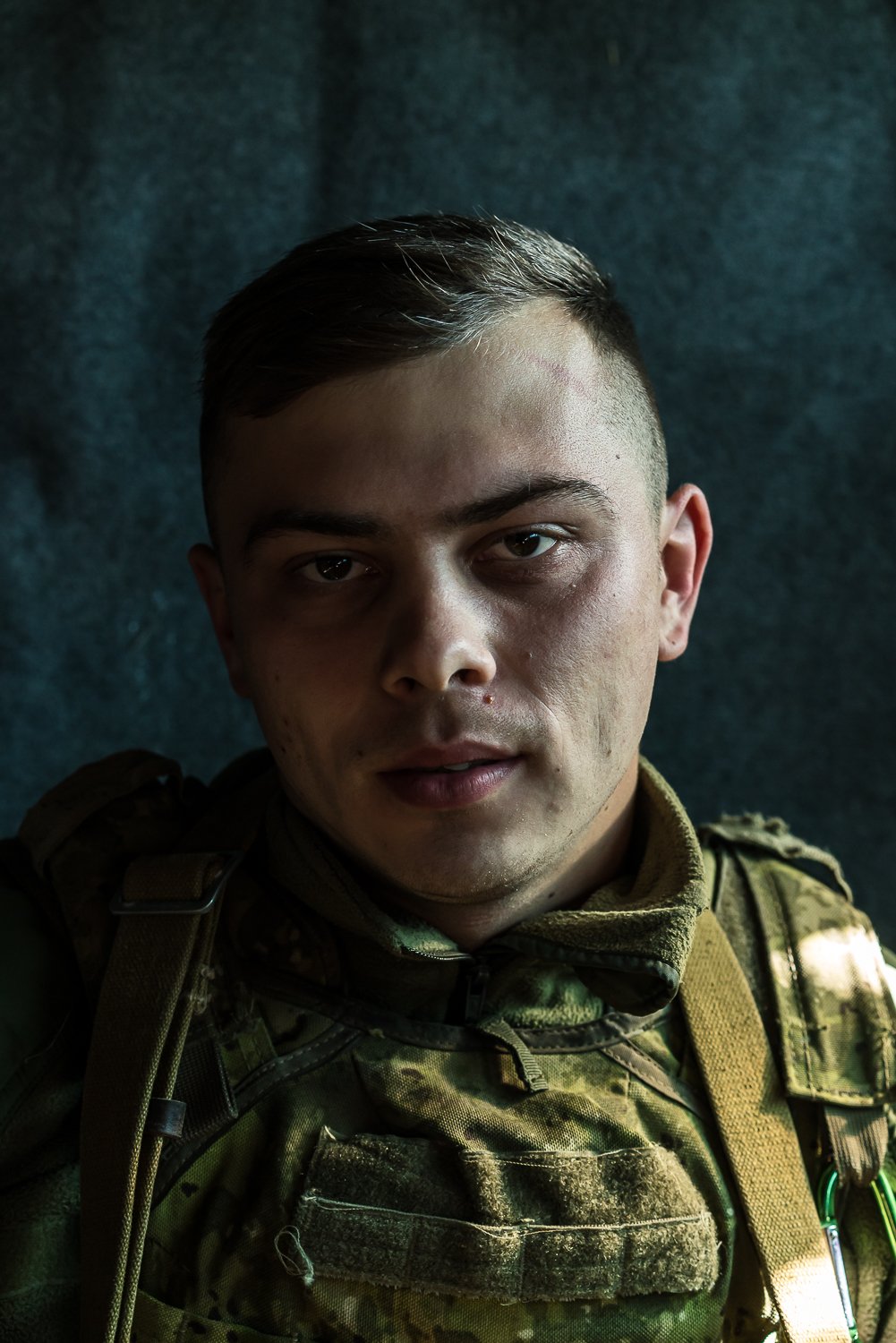  Oleksandr, 23, poses for a portrait in the bunker from which he monitors Russian-backed separatist forces from their respective disengagement positions on Friday, October 18, 2019 in Stanytsia Luhanska, Ukraine. 