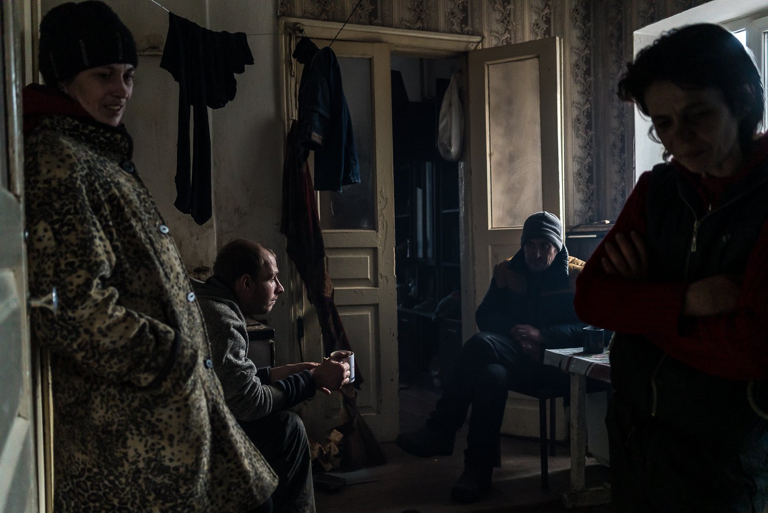  Olya Rud, Serhiy Chelkov, 32, a neighbor, and Vera Karpenko, 42, from left, in Karpenko's kitchen on Monday, January 31, 2022 in Hnutove, Ukraine. In 2015 Karpenko's husband was driving a tractor in a nearby field that he had been assured was clear 