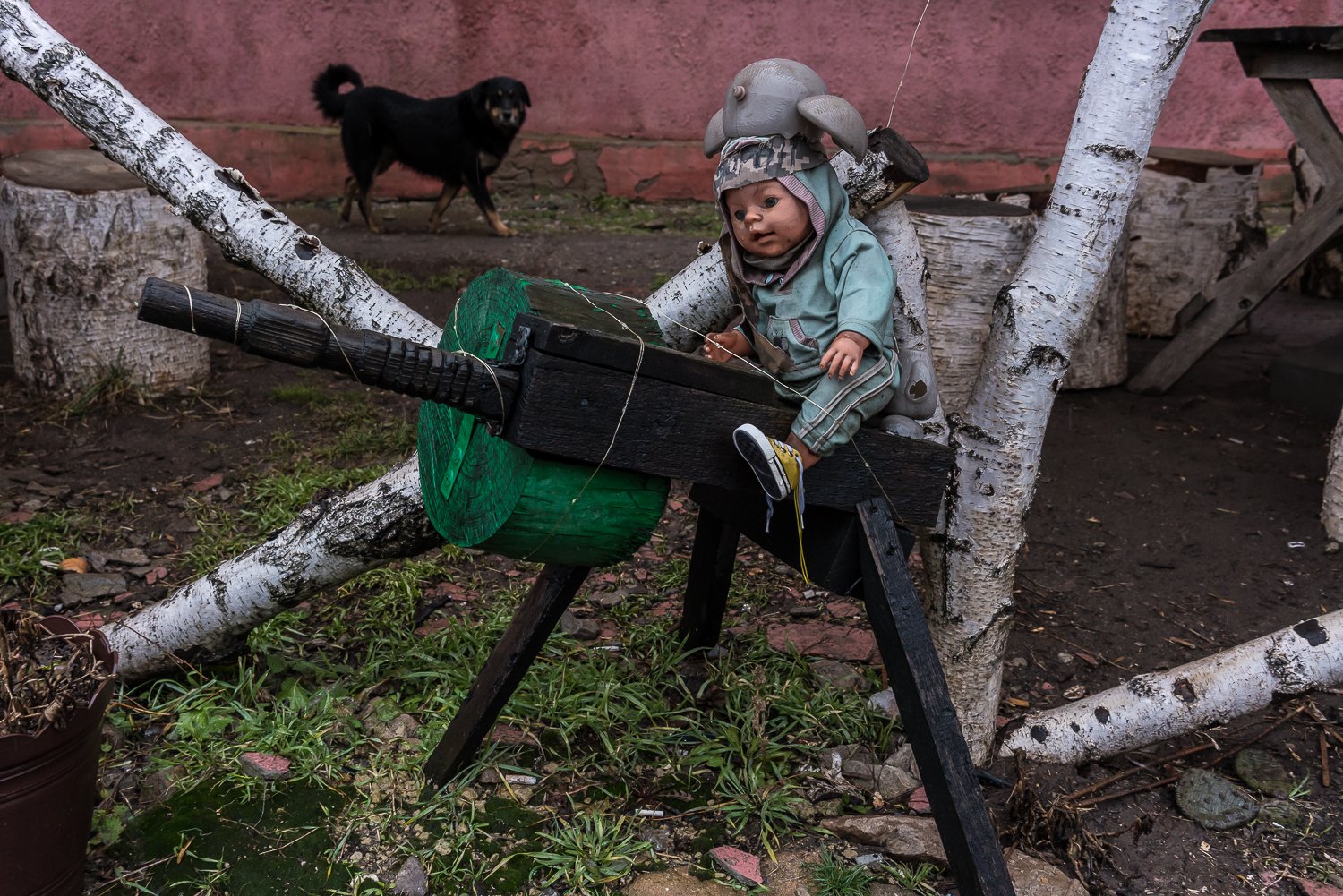  A doll sits on a wooden gun outside a shop on Tuesday, February 8, 2022 in Verkhnotoretske, Ukraine. 