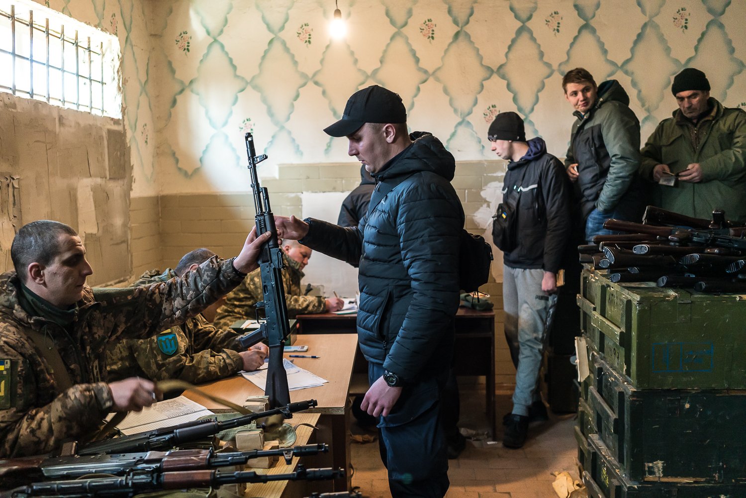  Military volunteers at a weapons storage facility receive weapons after the Ukrainian government announced they would arm civilians to resist the Russian invasion on Friday, February 25, 2022 in Fastiv, Ukraine. 