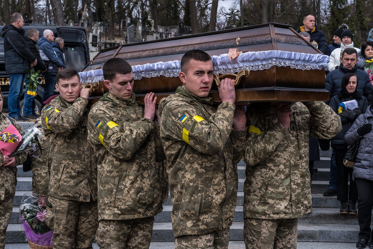  Ukrainian soldiers hold a casket containing the remains of fellow soldier Viktor Dudar, who was killed on March 2 in the war against Russia, at Lychakiv Cemetery on Tuesday, March 8, 2022 in Lviv, Ukraine. 