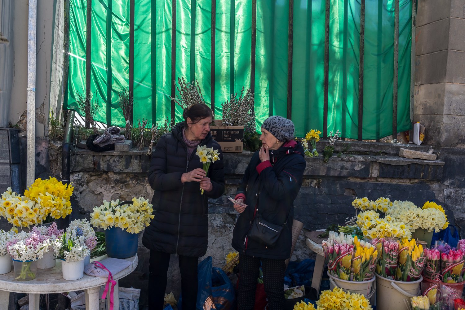  Flower sellers do business on the sidewalk on Thursday, April 14, 2022 in Lviv, Ukraine. 