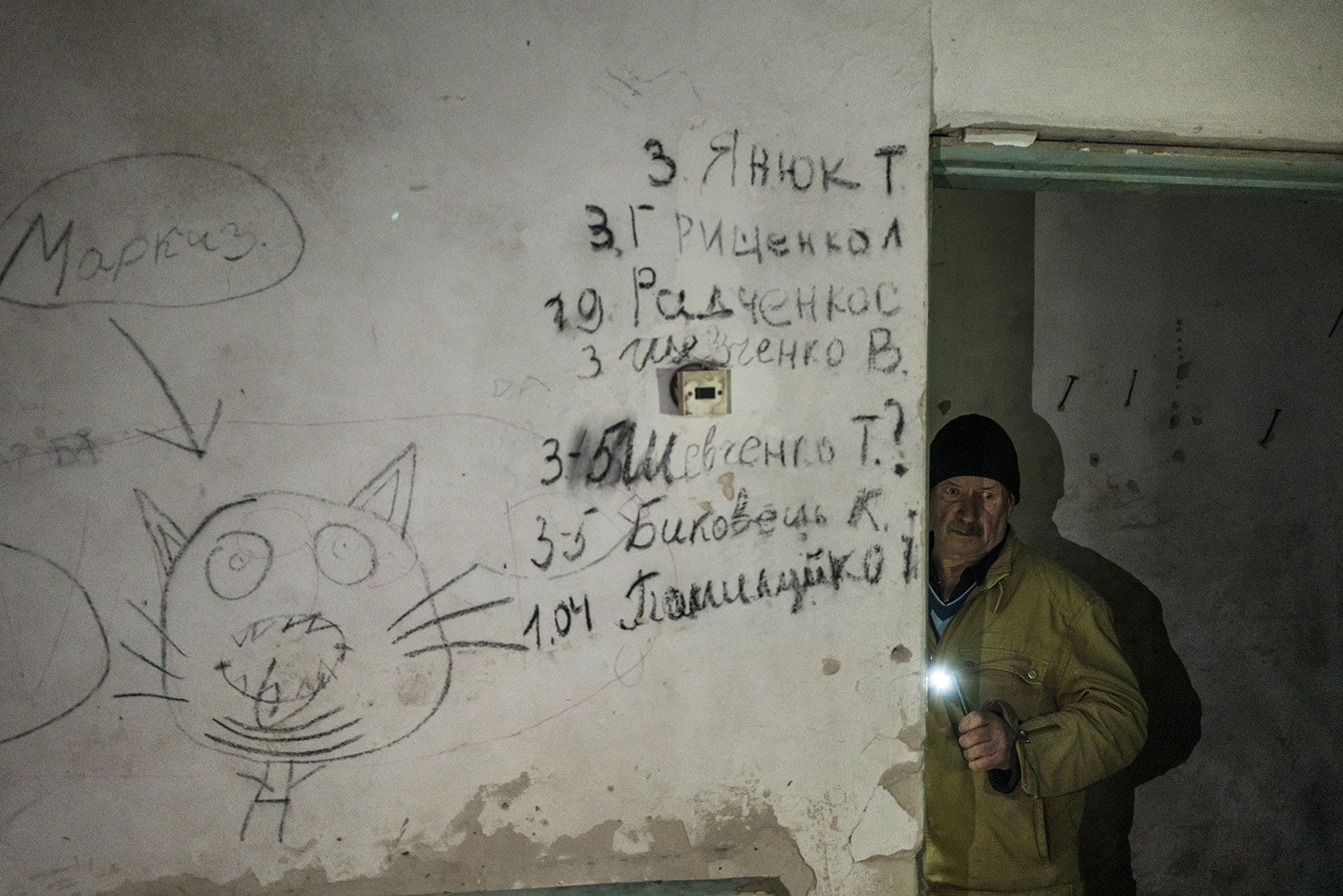  Ivan Polhui in the basement of the local school next to a list of the names of people executed by Russian forces on Wednesday, October 19, 2022 in Yahidne, Ukraine. For nearly the entire month of March, more than 300 local villagers, including Polhu