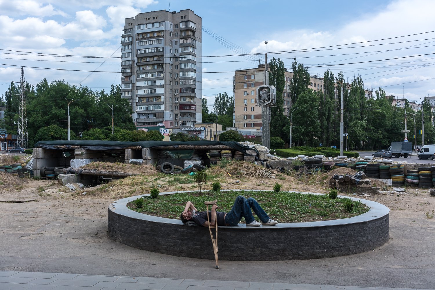  A man lays outside a supermarket near old military fortifications on Wednesday, June 7, 2023 in Mykolaiv, Ukraine. 