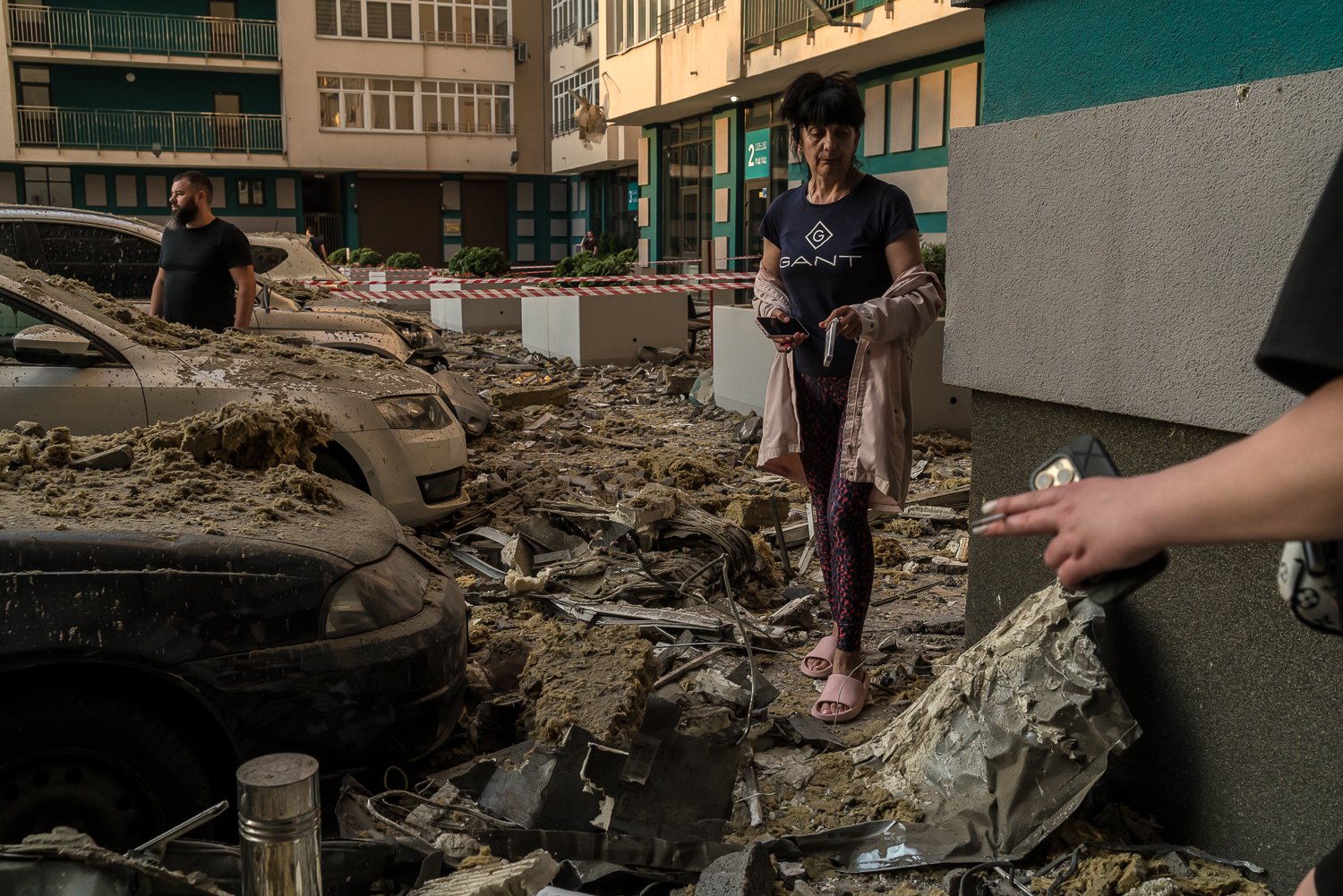  Residents at the scene of a high-rise residential building that was hit by a missile early in the morning on Saturday, June 24, 2023 in Kyiv, Ukraine. Five people died in the strike. 