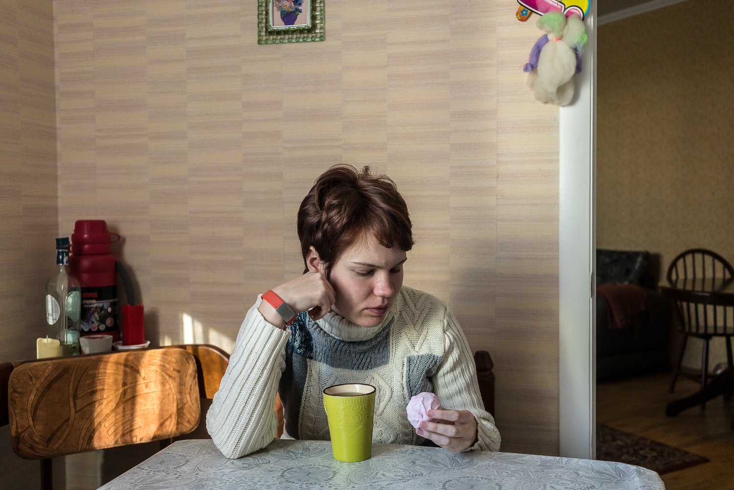  Maryna Klepets, 26, who has severe autism spectrum disorder, drinks tea and sweets at home on Thursday, February 23, 2023 in Kyiv, Ukraine. 