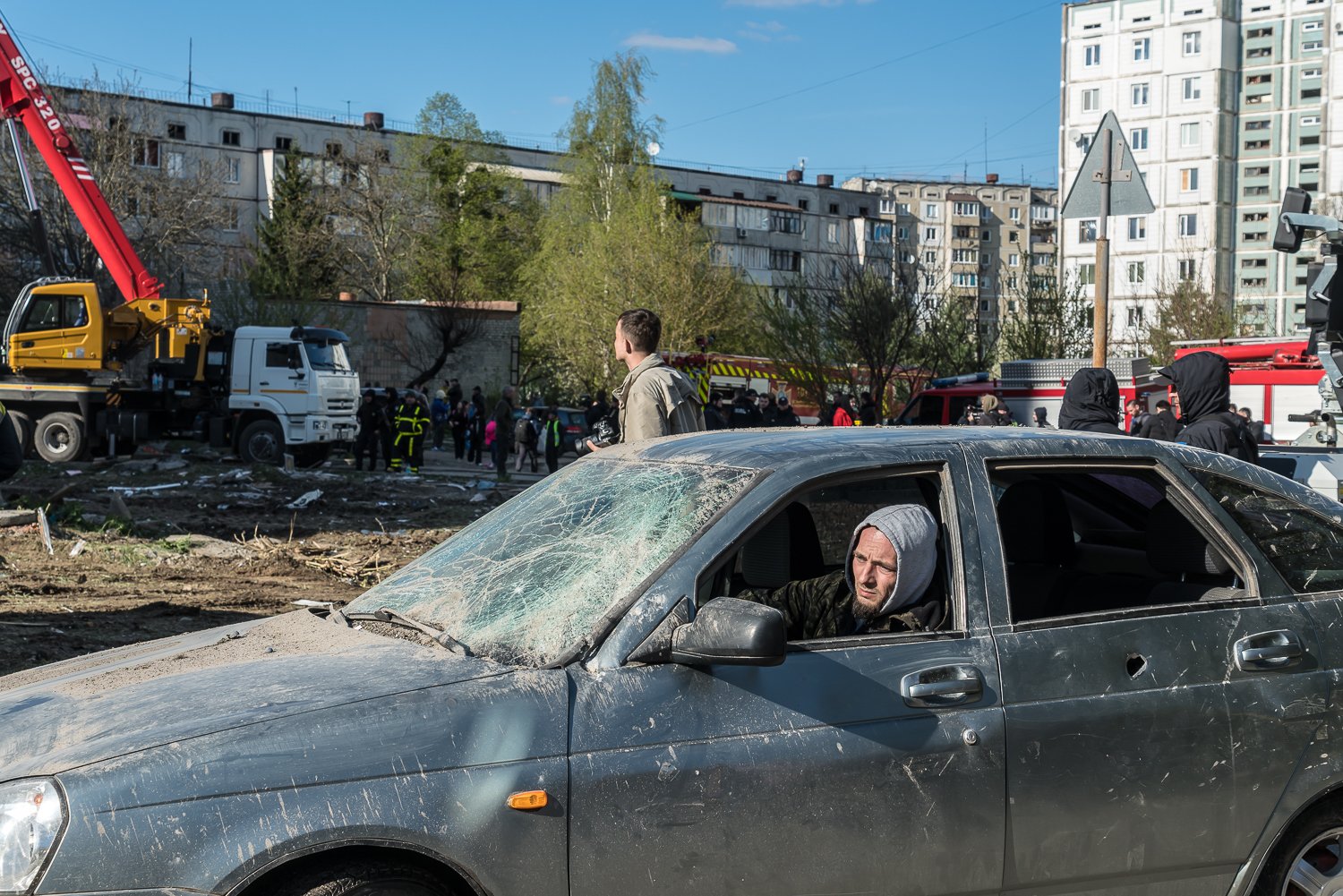  A man drives a car with a broken windshield and windows away from the scene of a Russian missile strike on a high-rise residential building on Friday, April 28, 2023 in Uman, Ukraine. At least 23 people were killed in the strike. 