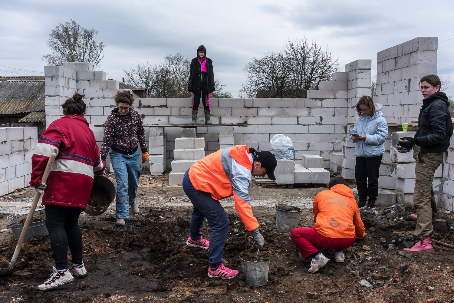  Daria Kosiakova, 25, center, a co-founder of Repair Together, works with a group of all-women volunteers to rebuild the house belonging to Nina Boyko and her children on Saturday, April 15, 2023 in Lukashivka, Ukraine. 