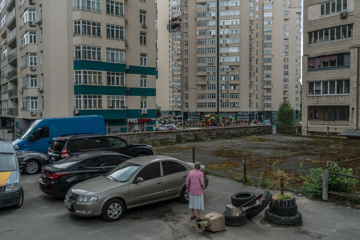  A woman watches rescue workers combing through destroyed apartments in a high-rise residential building that was hit by a missile early the previous morning on Sunday, June 25, 2023 in Kyiv, Ukraine. Authorities located the bodies of two additional 