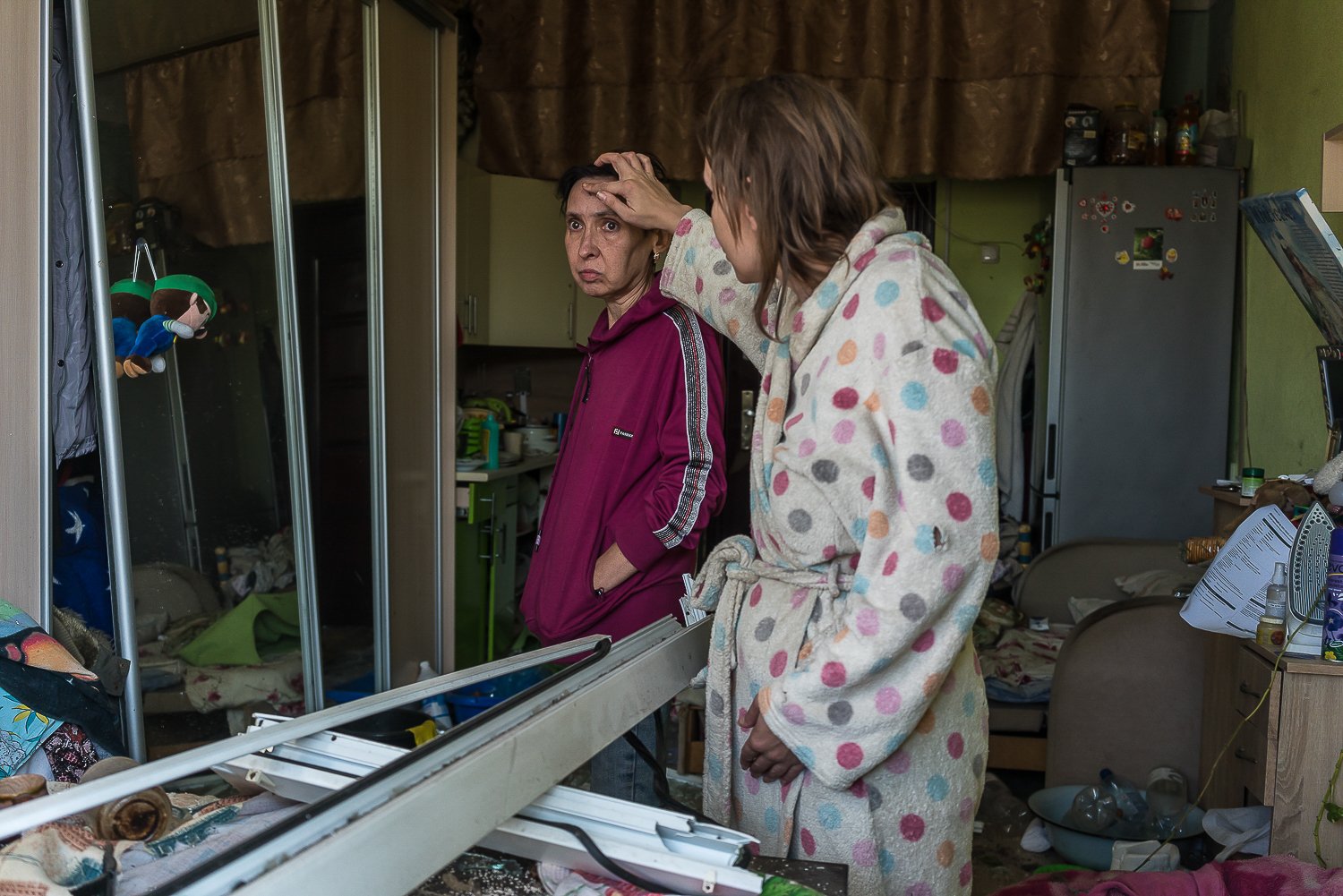  Ira, right, who did not want to provide her last name, examines a cut on her mother's forehead received when a Russian missile landed just outside the dormitory where they live in the Darnytskyi district, on the city's eastern bank of the Dnipro Riv