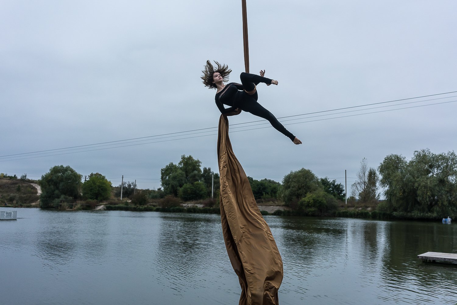  Yelyzaveta Malytsia, 14, performs an aerial silks routine at a gathering of young practitioners at a small lake on Sunday, October 1, 2023 in Kriukivshchyna, Ukraine. 