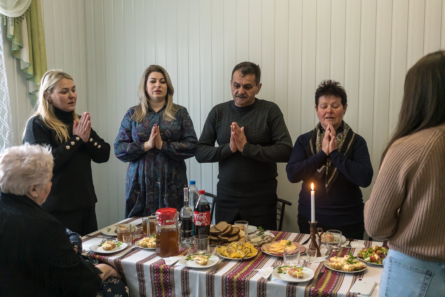  Family members pray before a lunch together following a memorial service for brothers Kyrylo and Vasyl Vyshyvany on Tuesday, March 12, 2024 in Duliby, Ukraine. Both brothers were Ukrainian soldiers who were killed in separate attacks in the first we