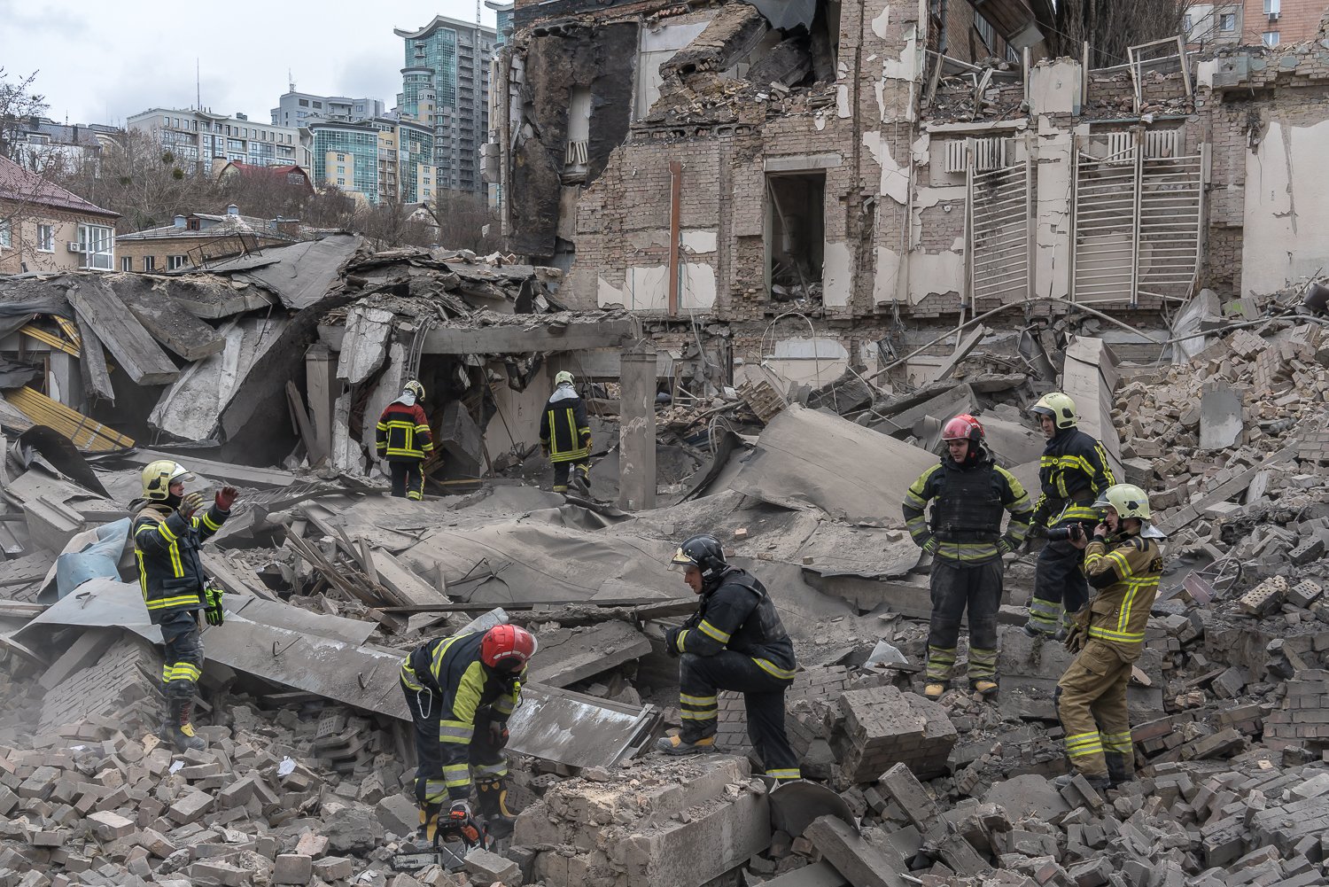  Rescue workers sift through the rubble of a gymnasium destroyed by a Russian missile on Monday, March 25, 2024 in Kyiv, Ukraine. Local authorities stated that two ballistic missiles were shot down over the city, with the remnants of one striking the