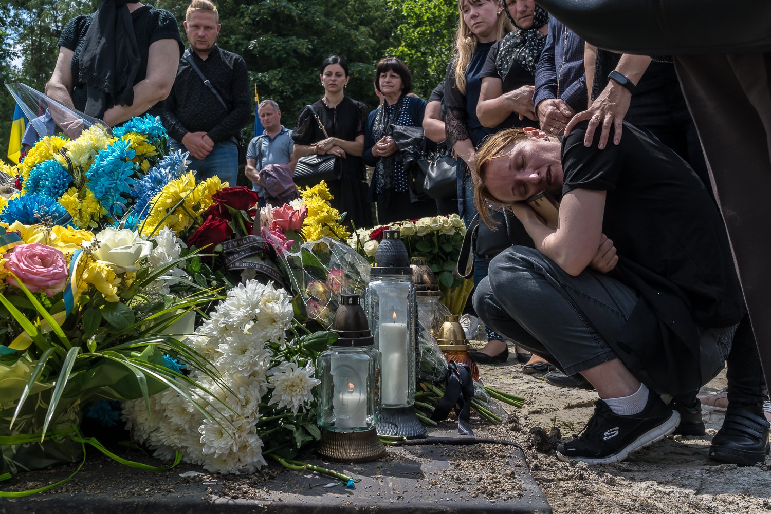  Olena Didukh, the wife of Ukrainian soldier Bohdan Didukh, hugs his photograph following his burial at Lychakiv Cemetery on Monday, June 19, 2023 in Lviv, Ukraine. 