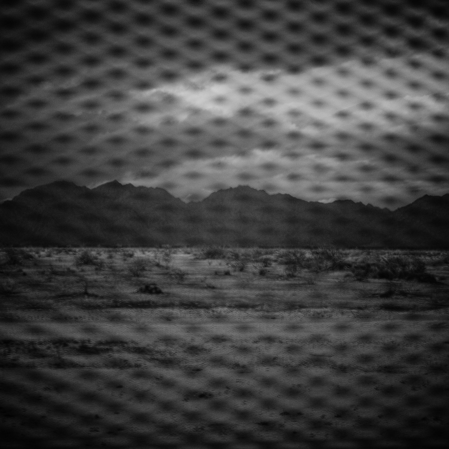  Mountains in the United States are seen from the Sonoran Desert in Mexico through the fence marking the border between the two countries. 
