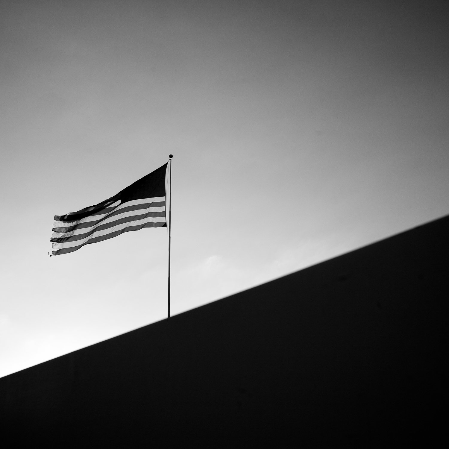  An American flag flies behind a wall in Arizona City, Arizona. 