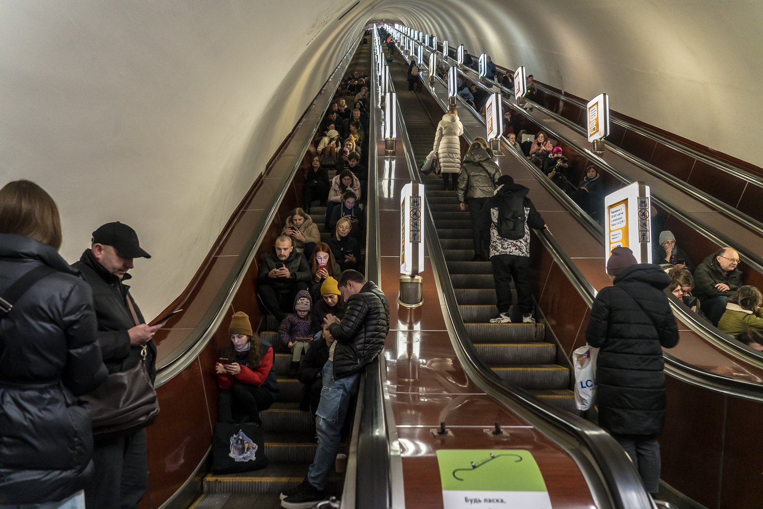  People gather on escalators in an underground metro station after air raid sirens sounded in Kyiv and there were reports of explosions, either from Russian missiles or from Ukraine's air defense system taking them down, on Tuesday, November 15, 2022