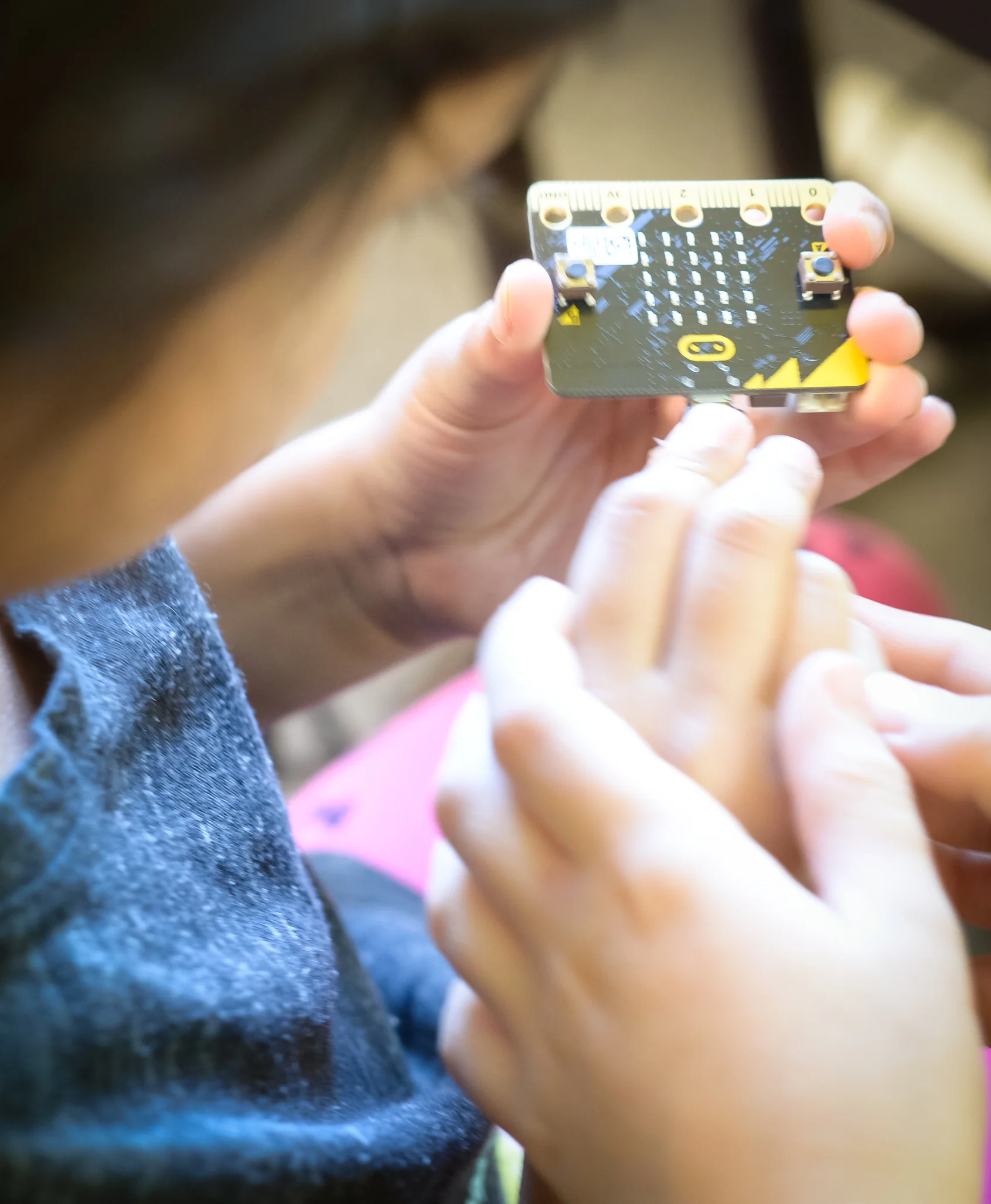 Our student using a Micro Bit, a tiny programmable computer