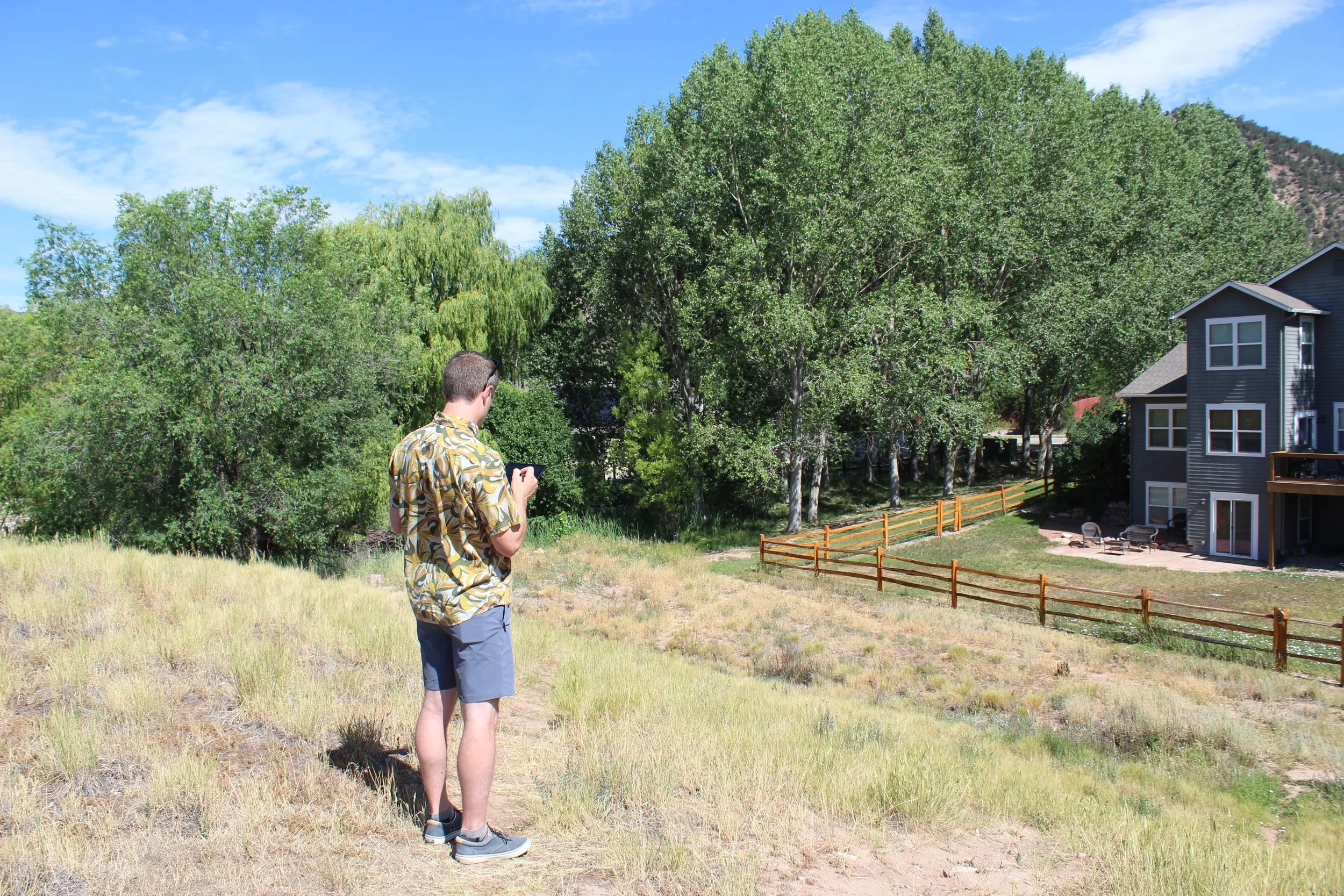  Sam Feuerborn evaluating vegetation and fuel loads along the property's edge. 