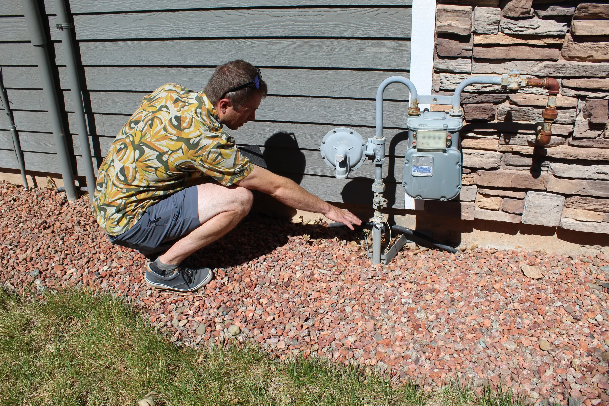  Sam Feuerborn checking utility connections and surrounding vegetation for ignition risk. 