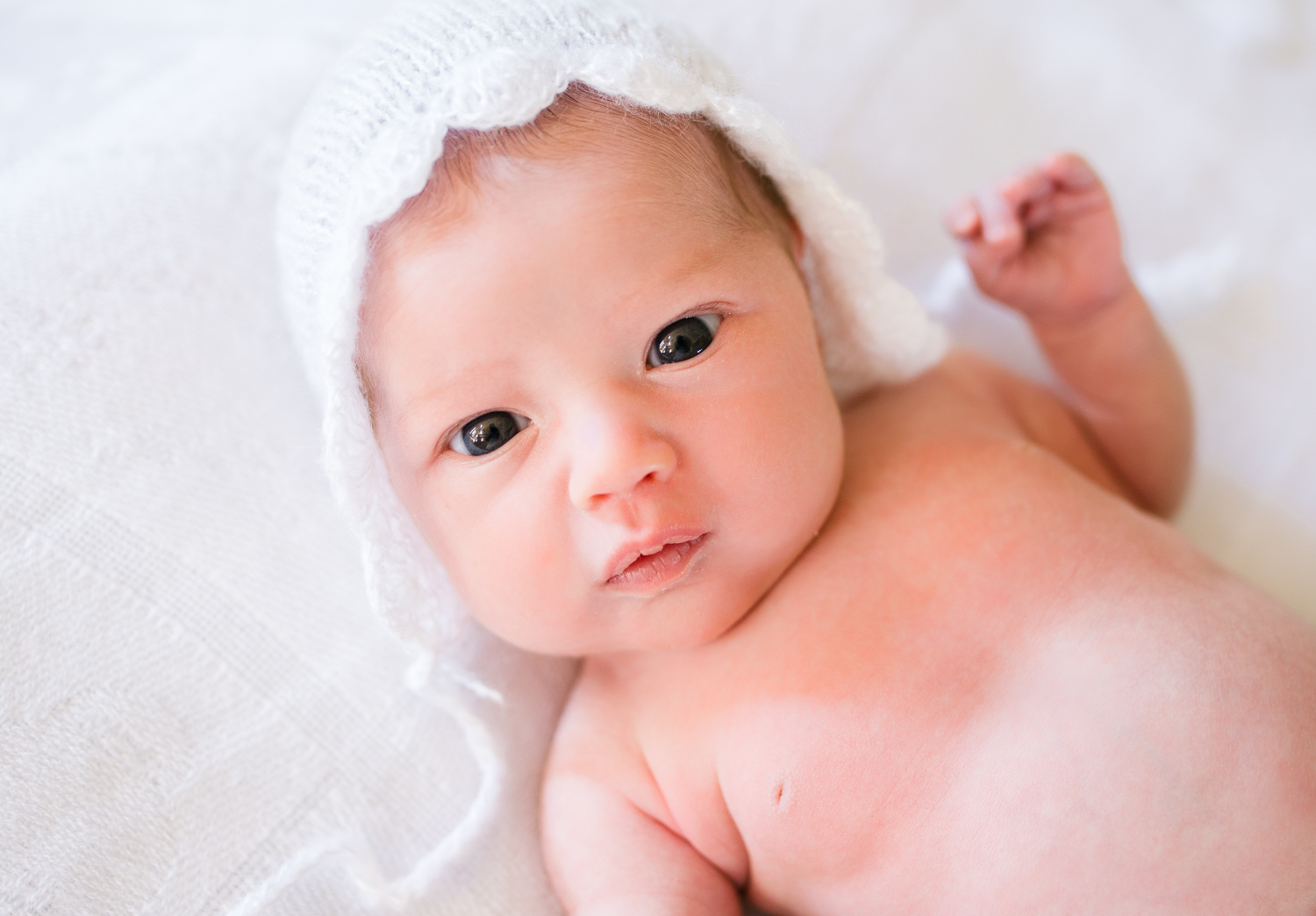 newborn baby in white bonnet - plymouth newborn photographer