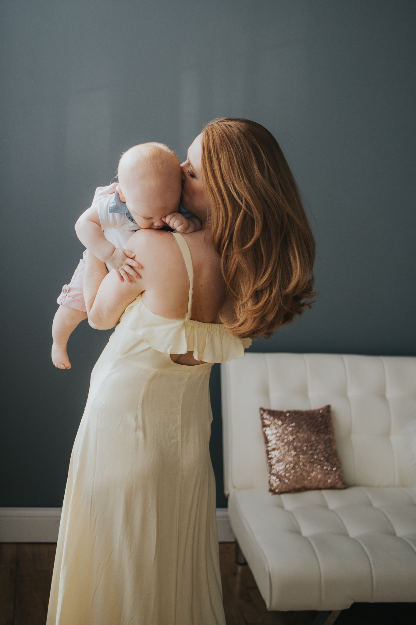 mommy in yellow dress kissing her baby boy - amg photography