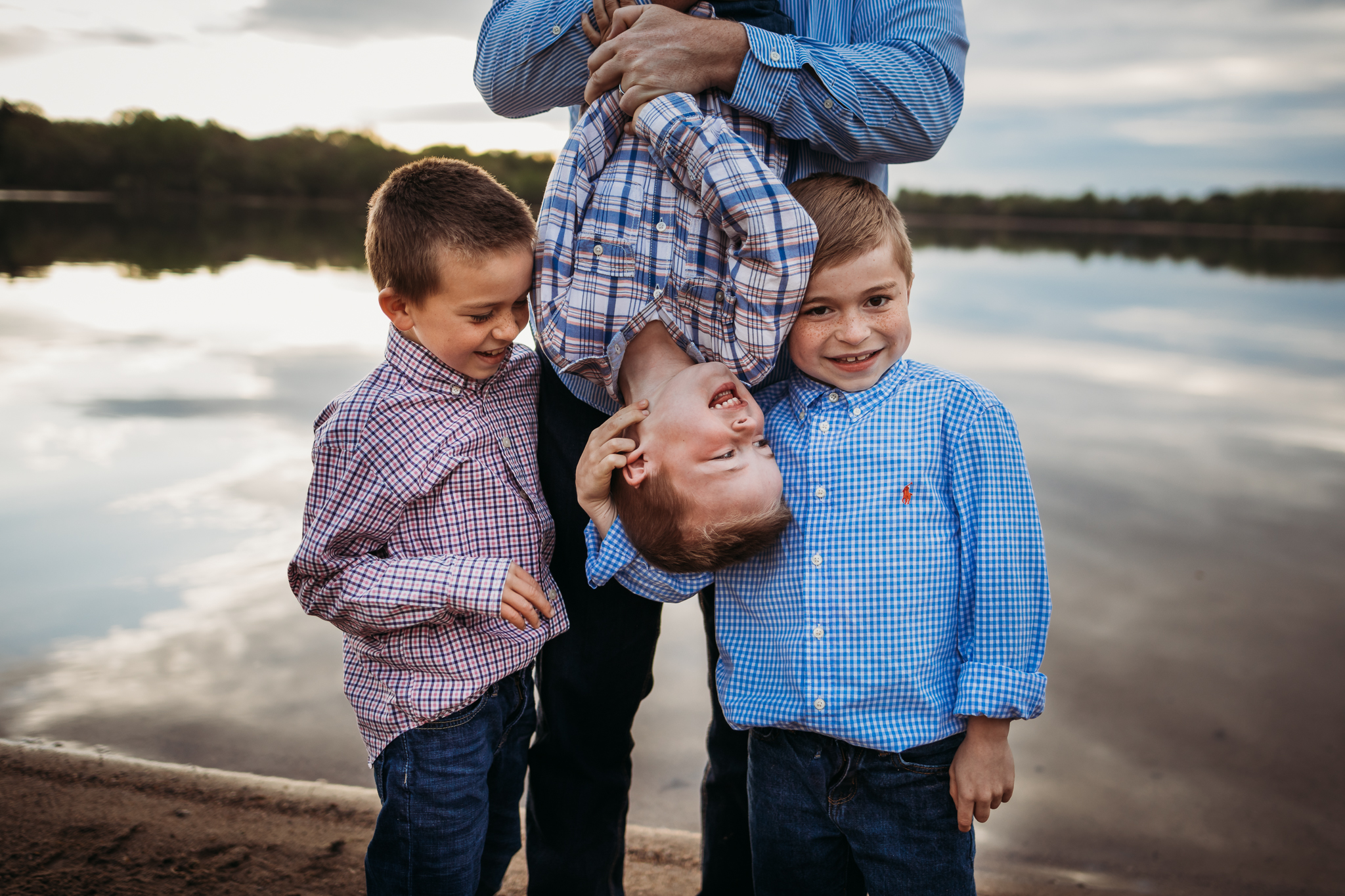 dad holding his three boys by a lake - Minneapolis Family Photographer