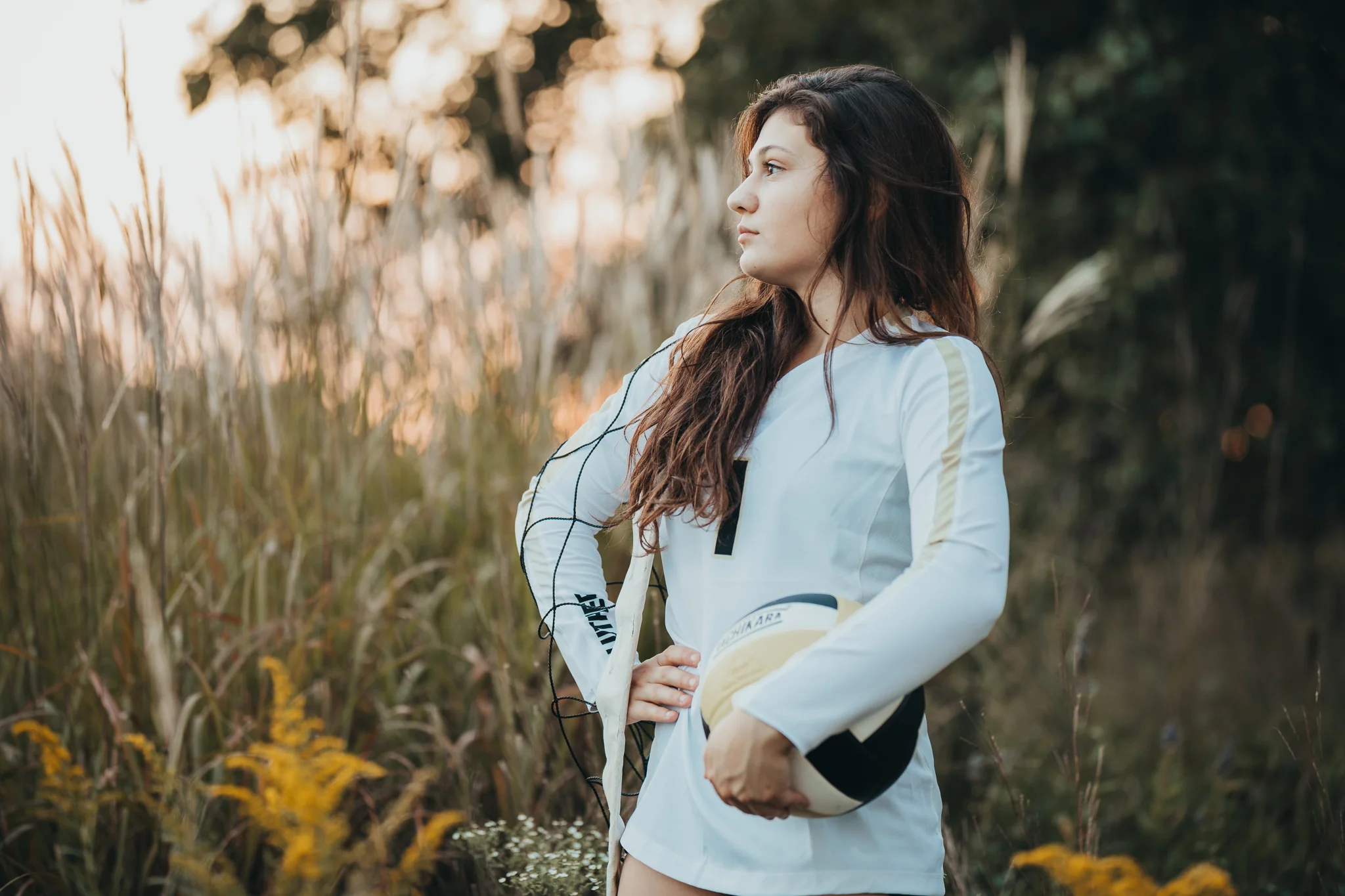 volleyball player holding a ball in a field at sunset | AMG Photography | Noerenberg Gardens | Wayzata