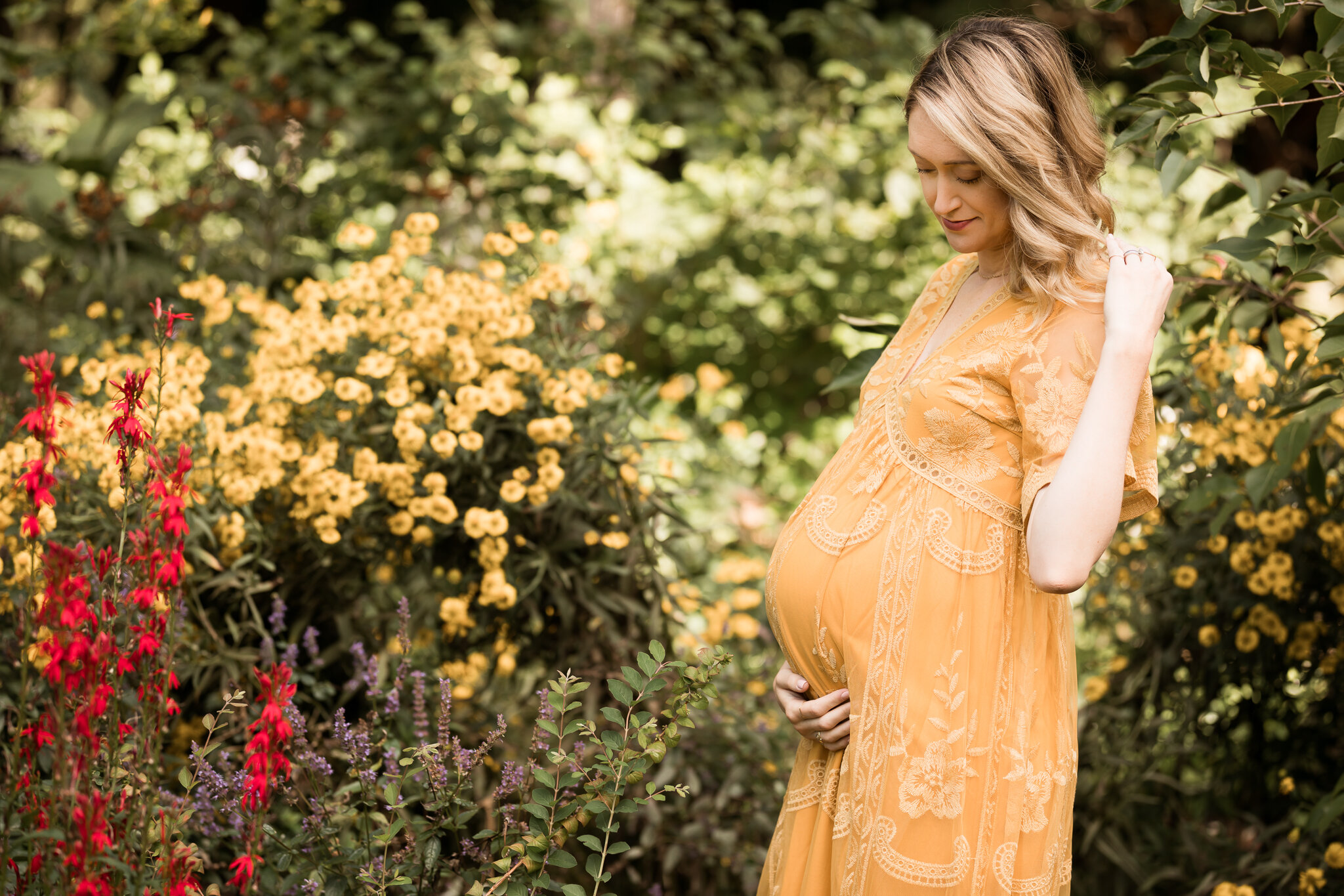 pregnant woman in golden dress by flowers - Minnesota Maternity Photographer