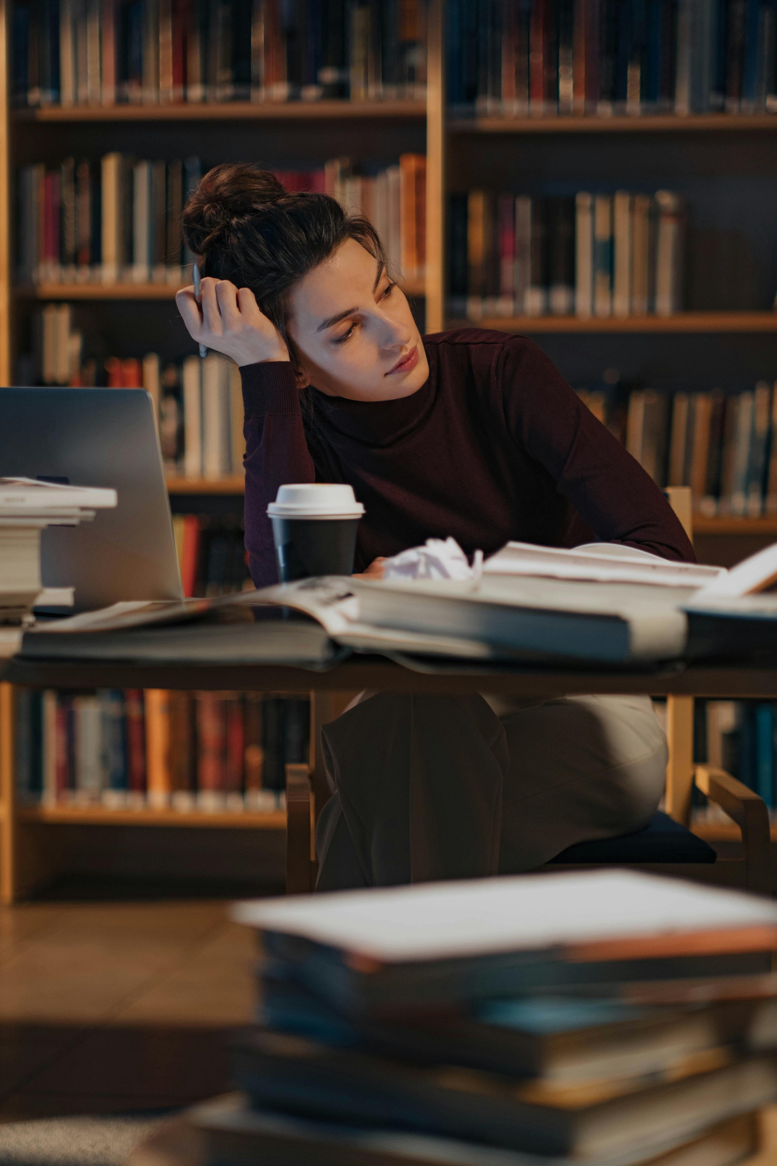 A woman thinking at a desk