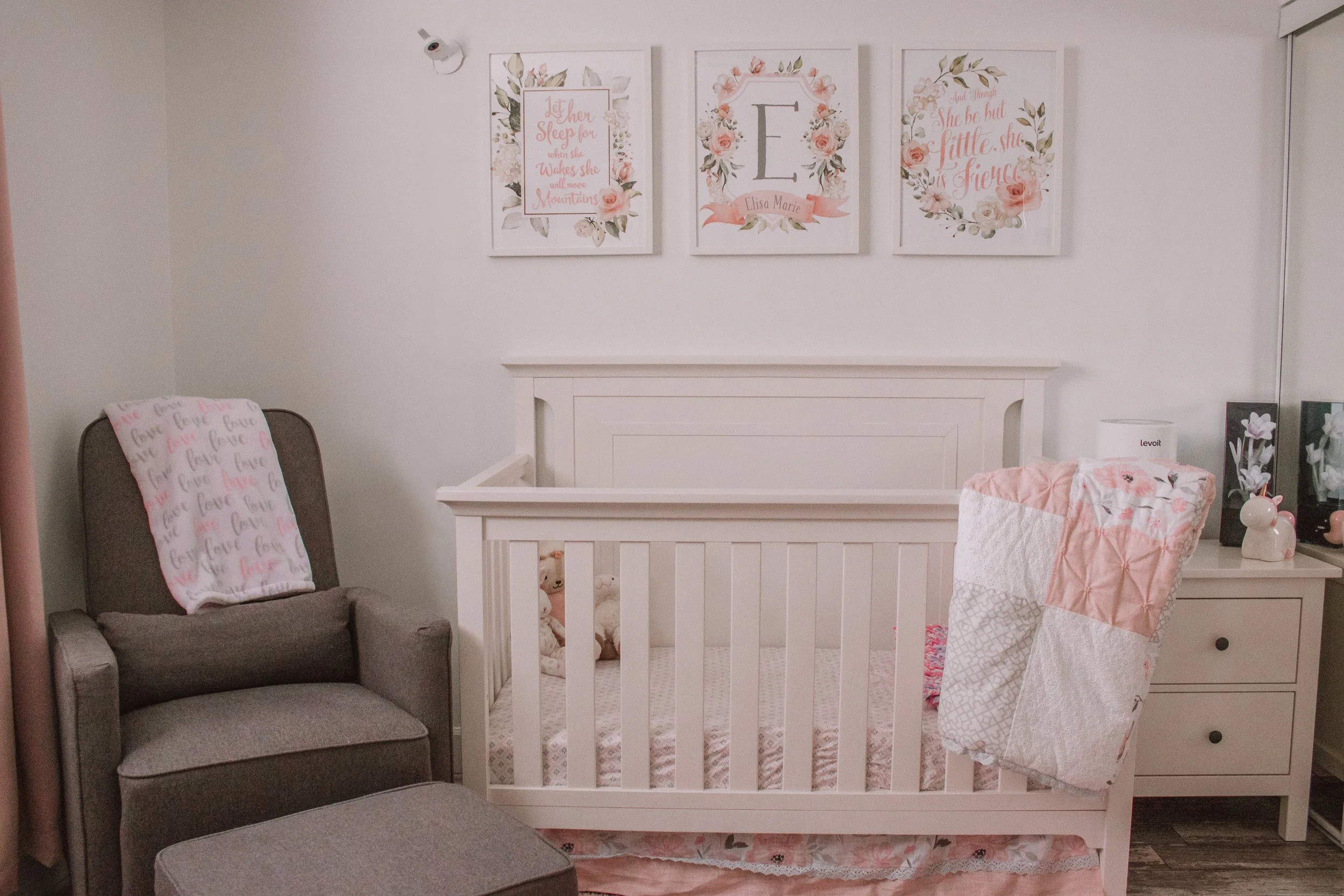 Since we live in a basement apartment, I kept the furniture and bedding light and bright. This helped make the space look and feel bigger. Crib , Sheet Set , Bedding Set , Rocking Chair , Love Blanket , Photos above Crib