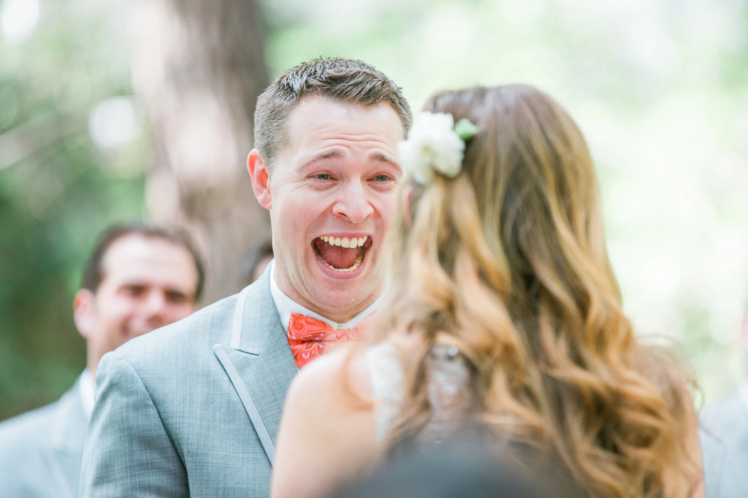 A Groom laughs during the ceremony