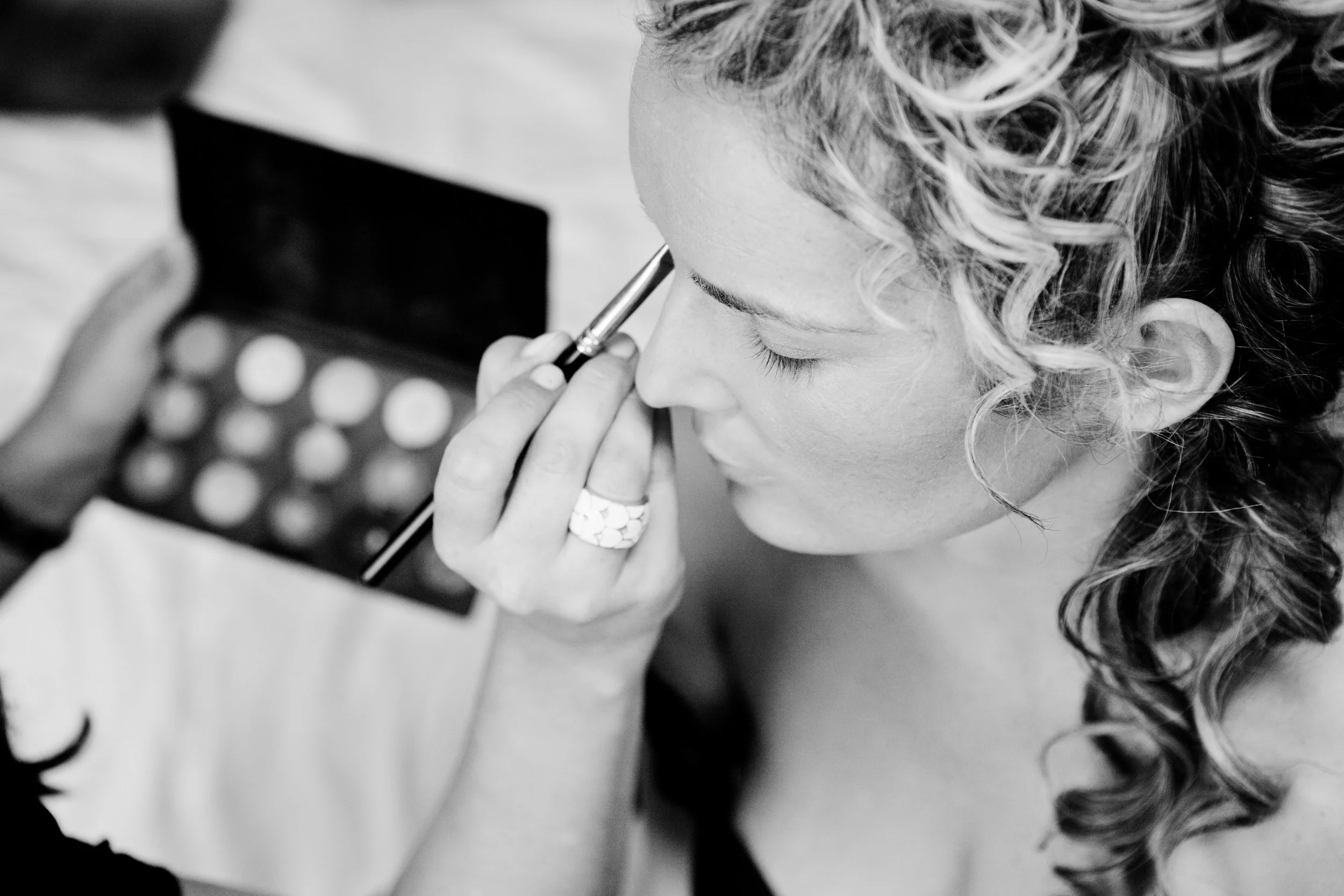 A bride has her makeup done