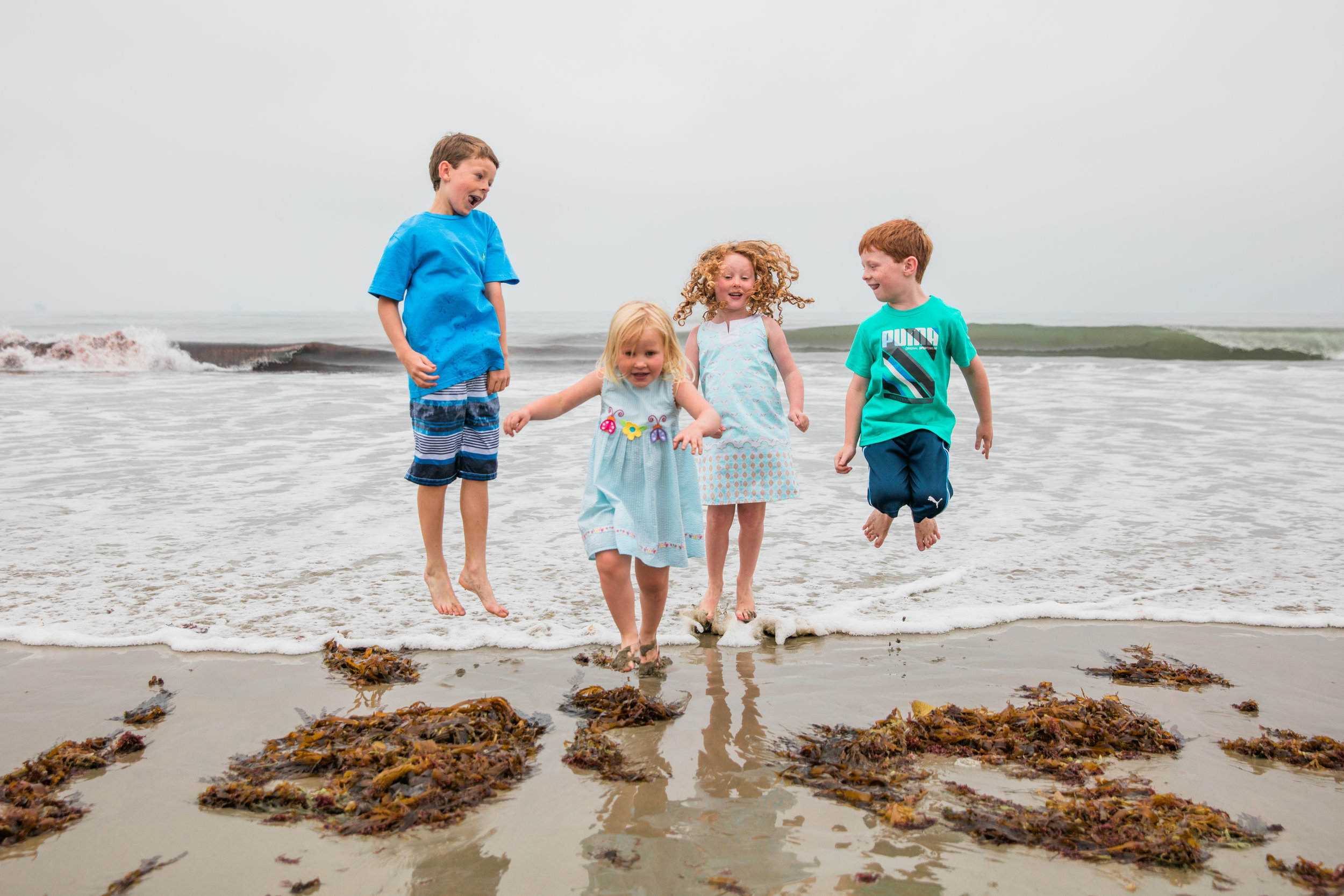 Kids Jumping On The Beach