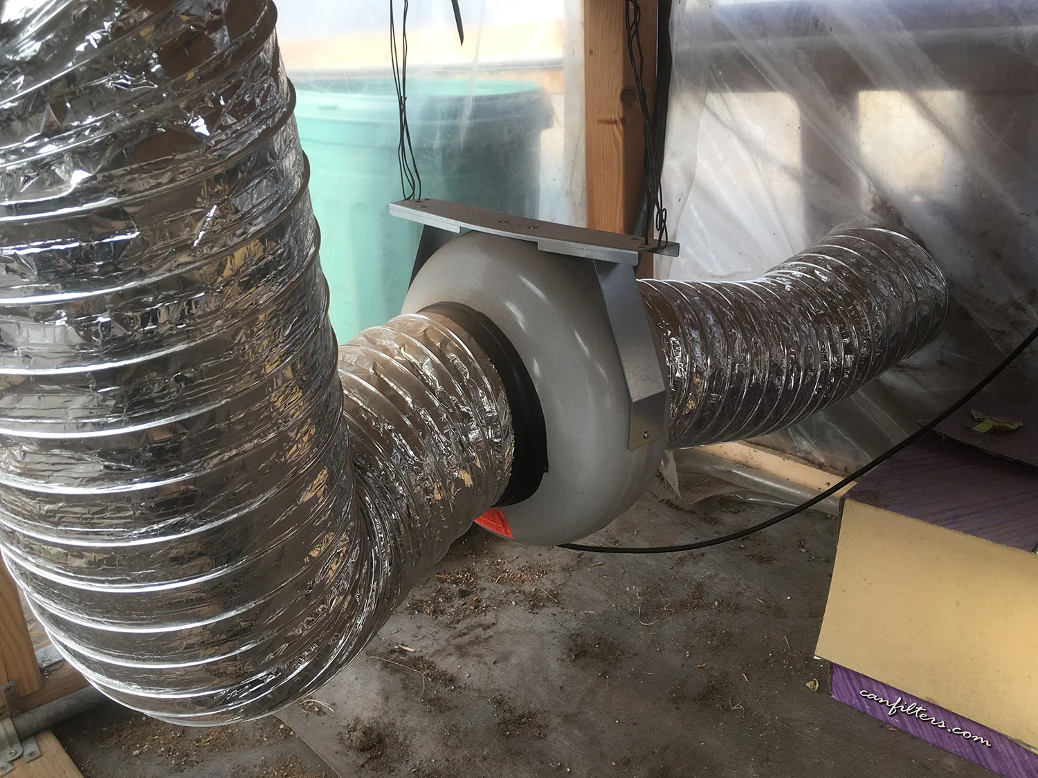 Intake fan. The silver tubing connects to the outside world on the north side of the hoop house.