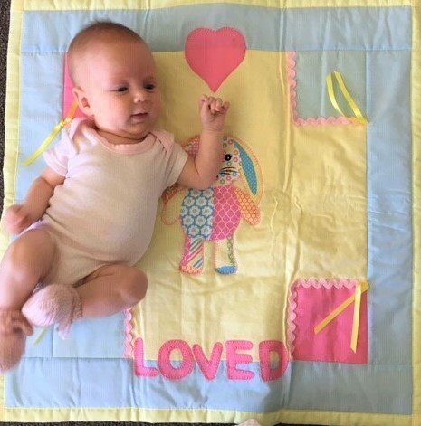 baby and pink and yellow quilt.jpg