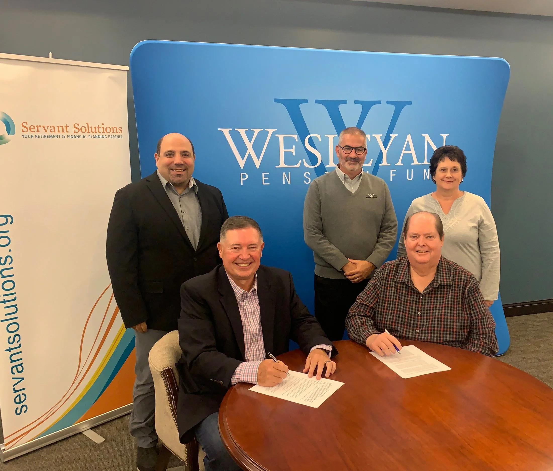 Nabil Safi and Jim O’Bold of Servant Solutions with Jim Weinmann, Craig Dunn and Cindy Linder of Wesleyan Pension Fund at the administrative services contract signing.