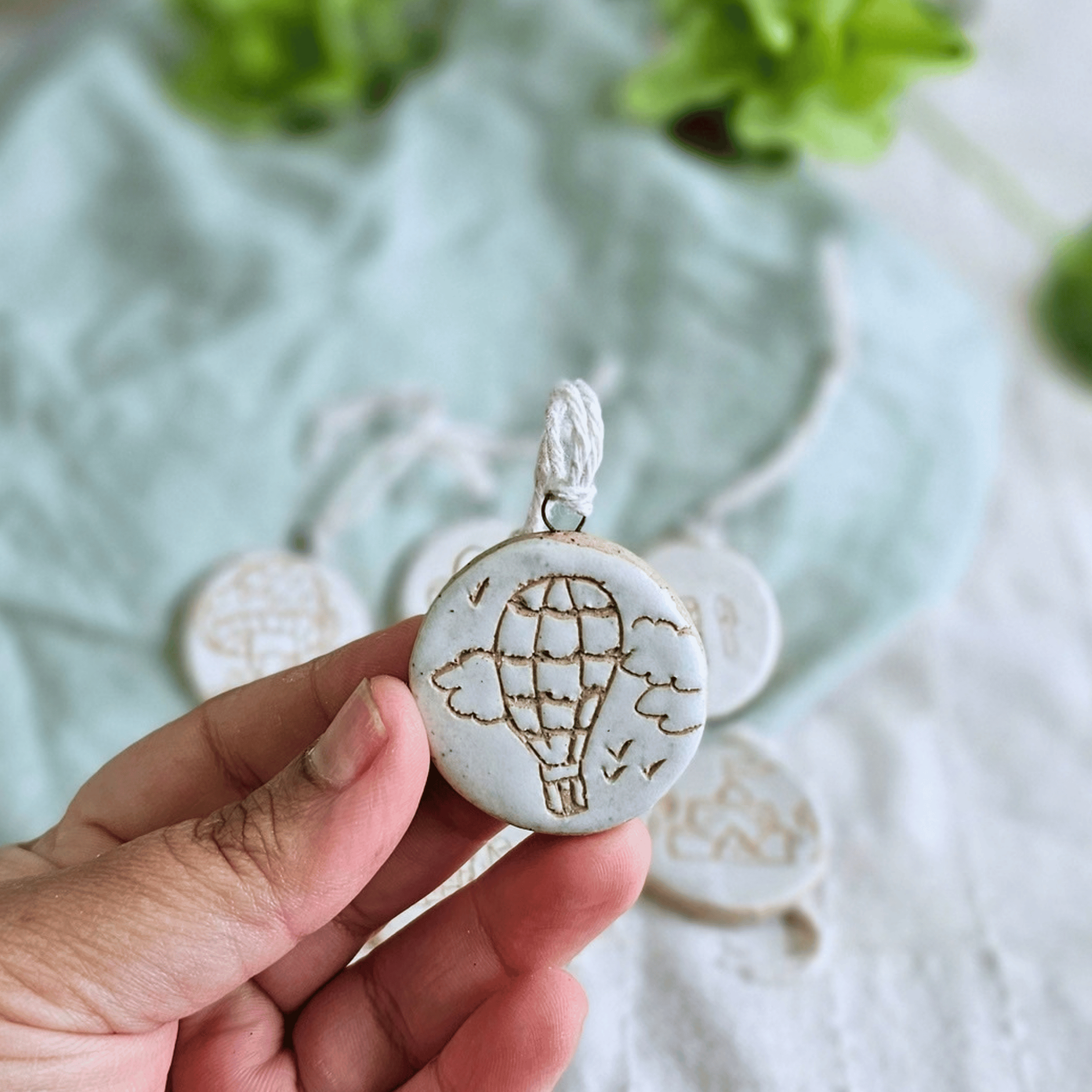 Mini Ornaments_sgraffito_white glaze_hot air ballon and clouds.png